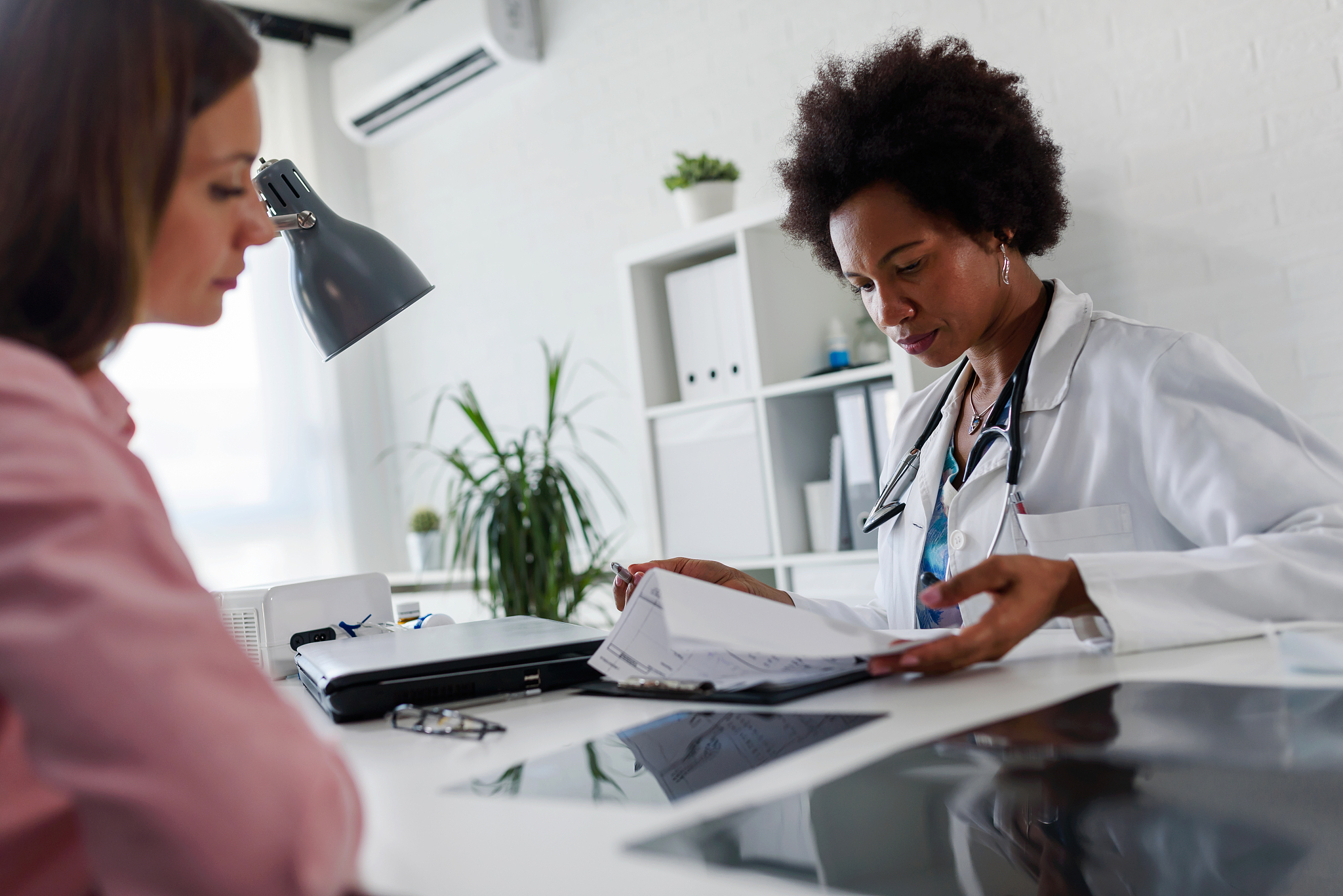 female doctor looking at test results of her patient. doctor and