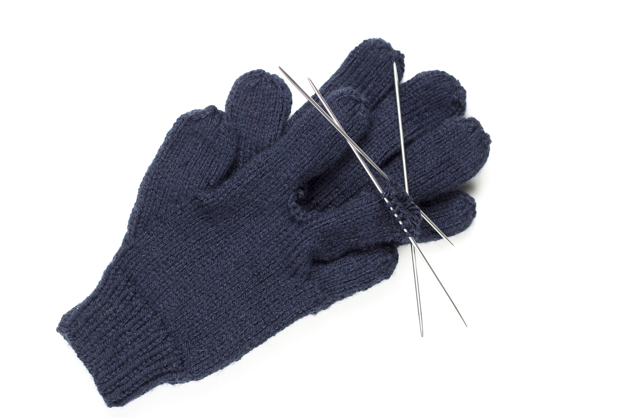 knitted gloves, knitting needles on a white background