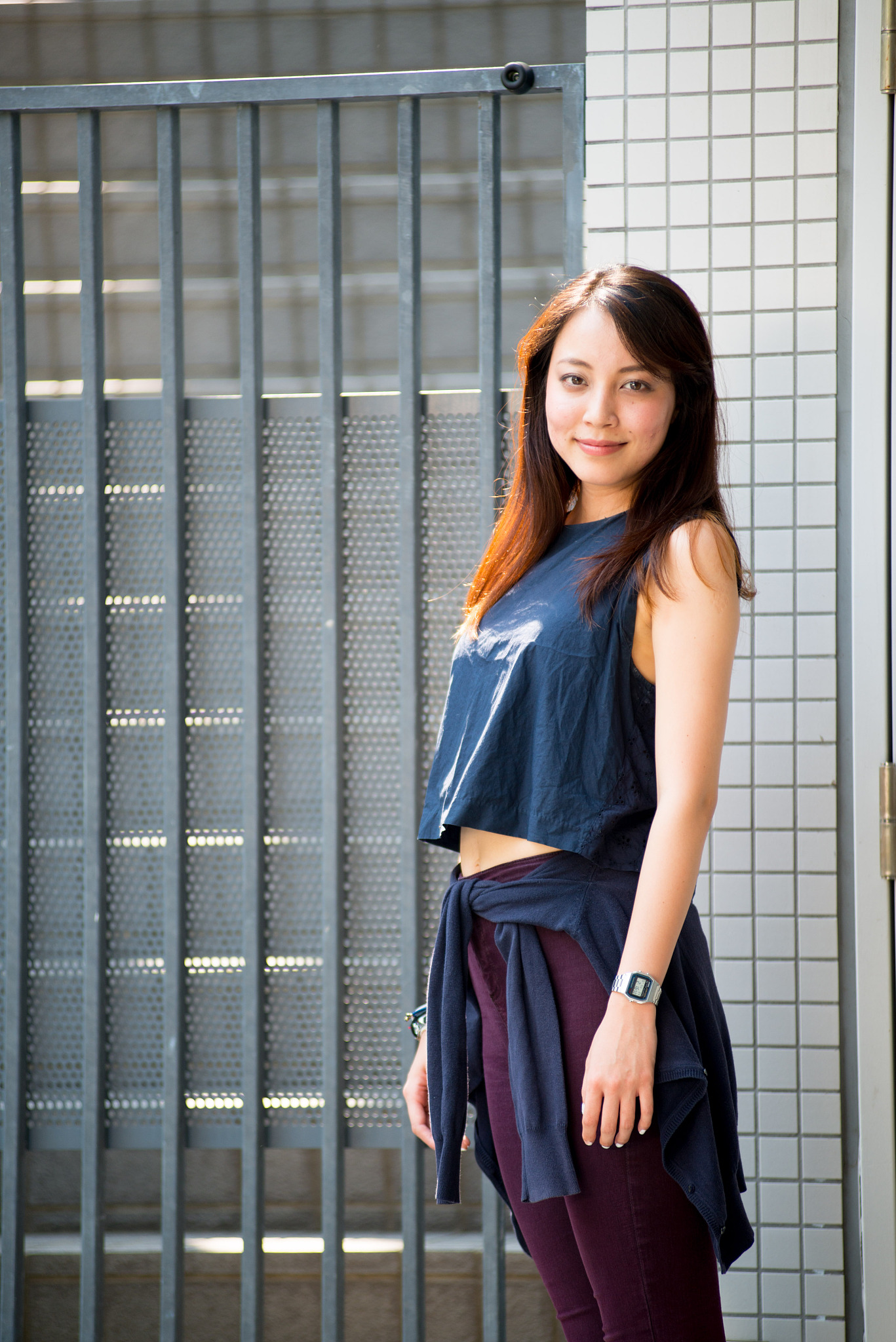 asian female model poses for pictures on the street