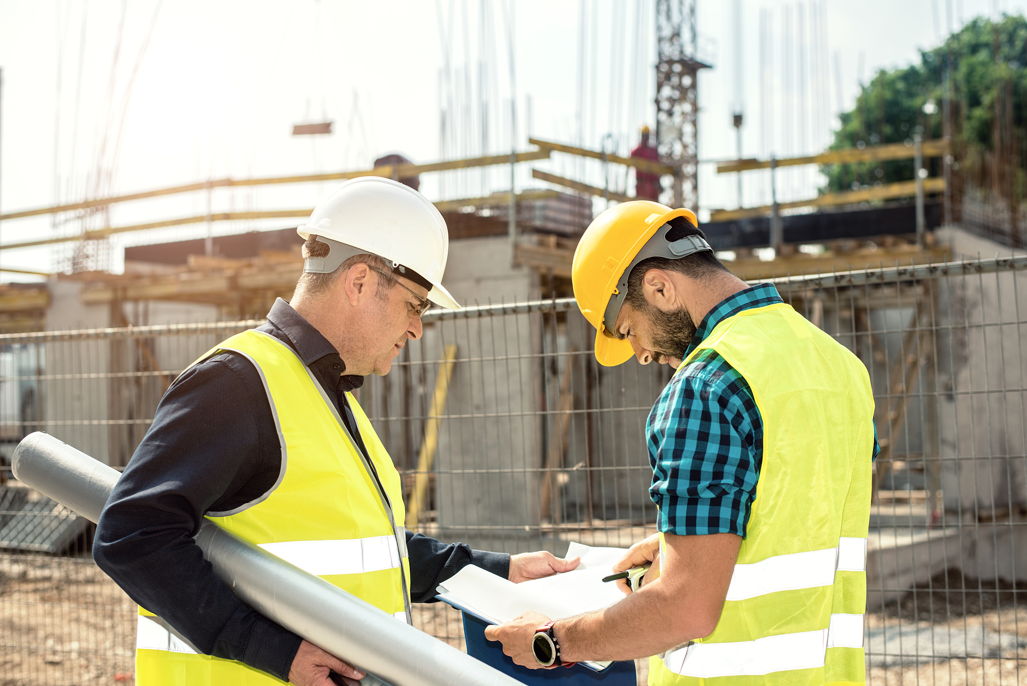 engineer and construction site manager dealing with blueprints a
