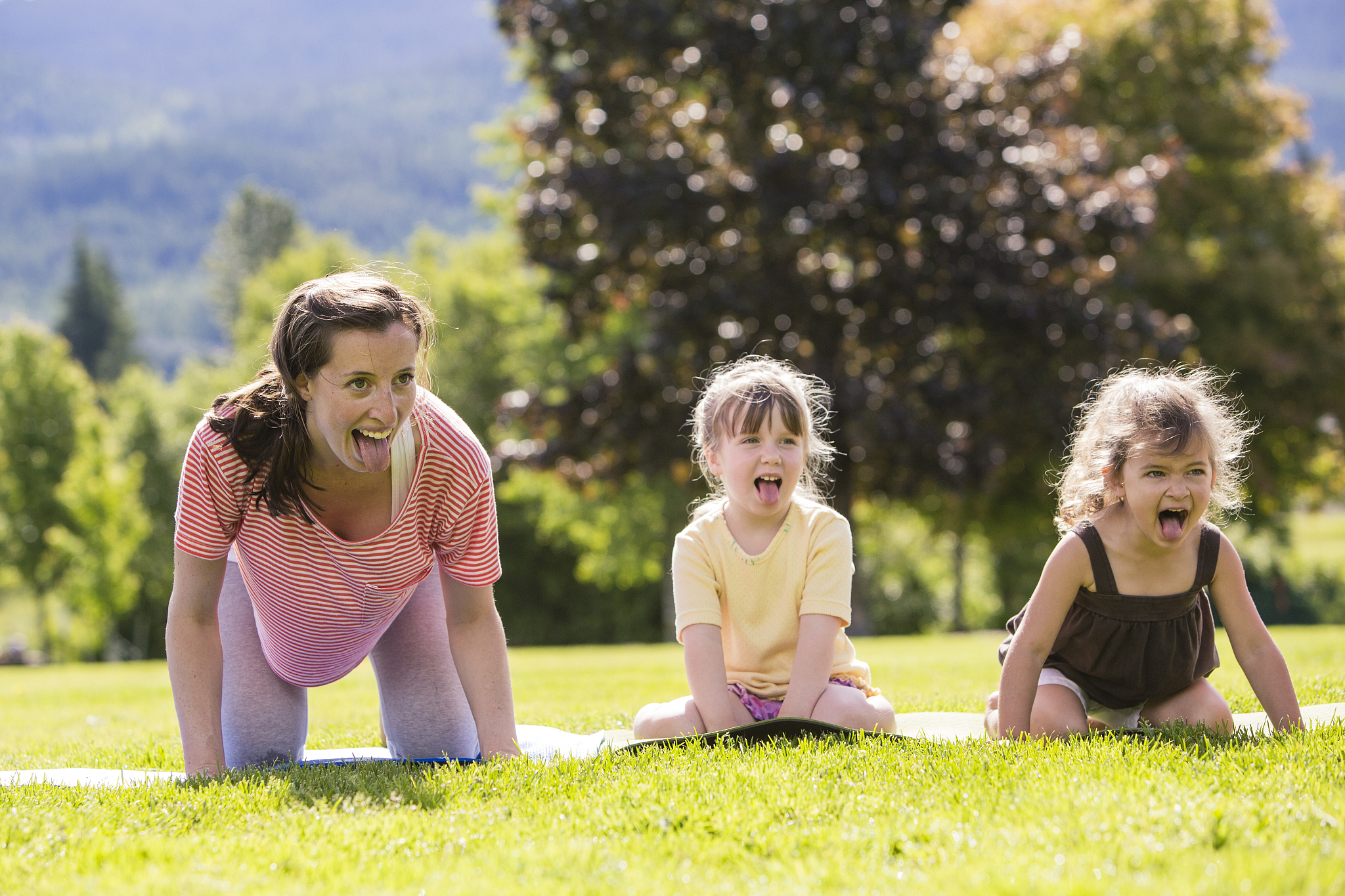 little girls and teacher laughing and showing tongue.