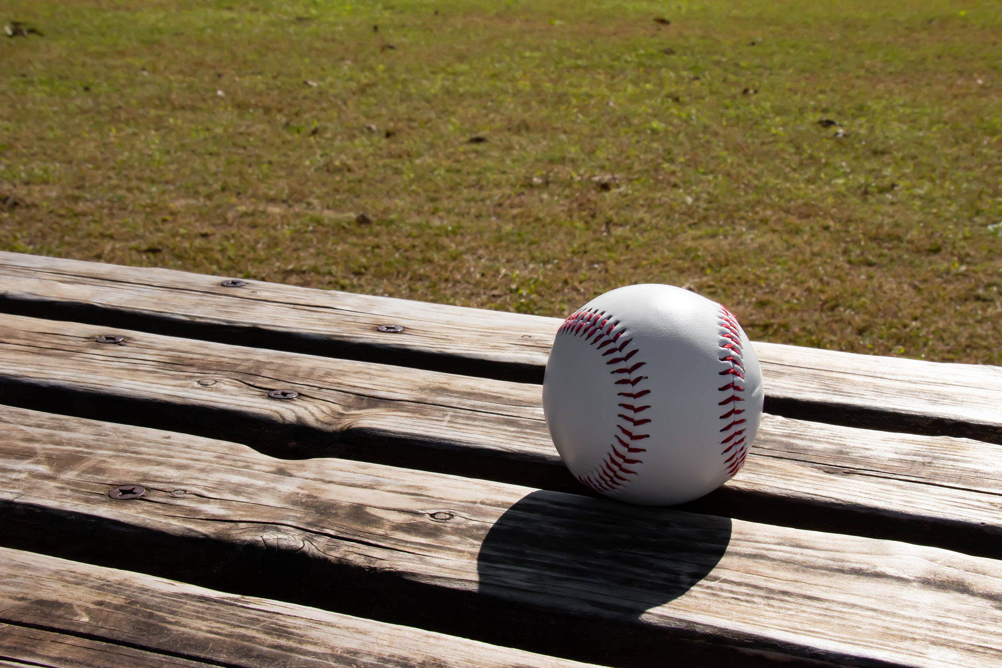baseball field and hard ball and bench