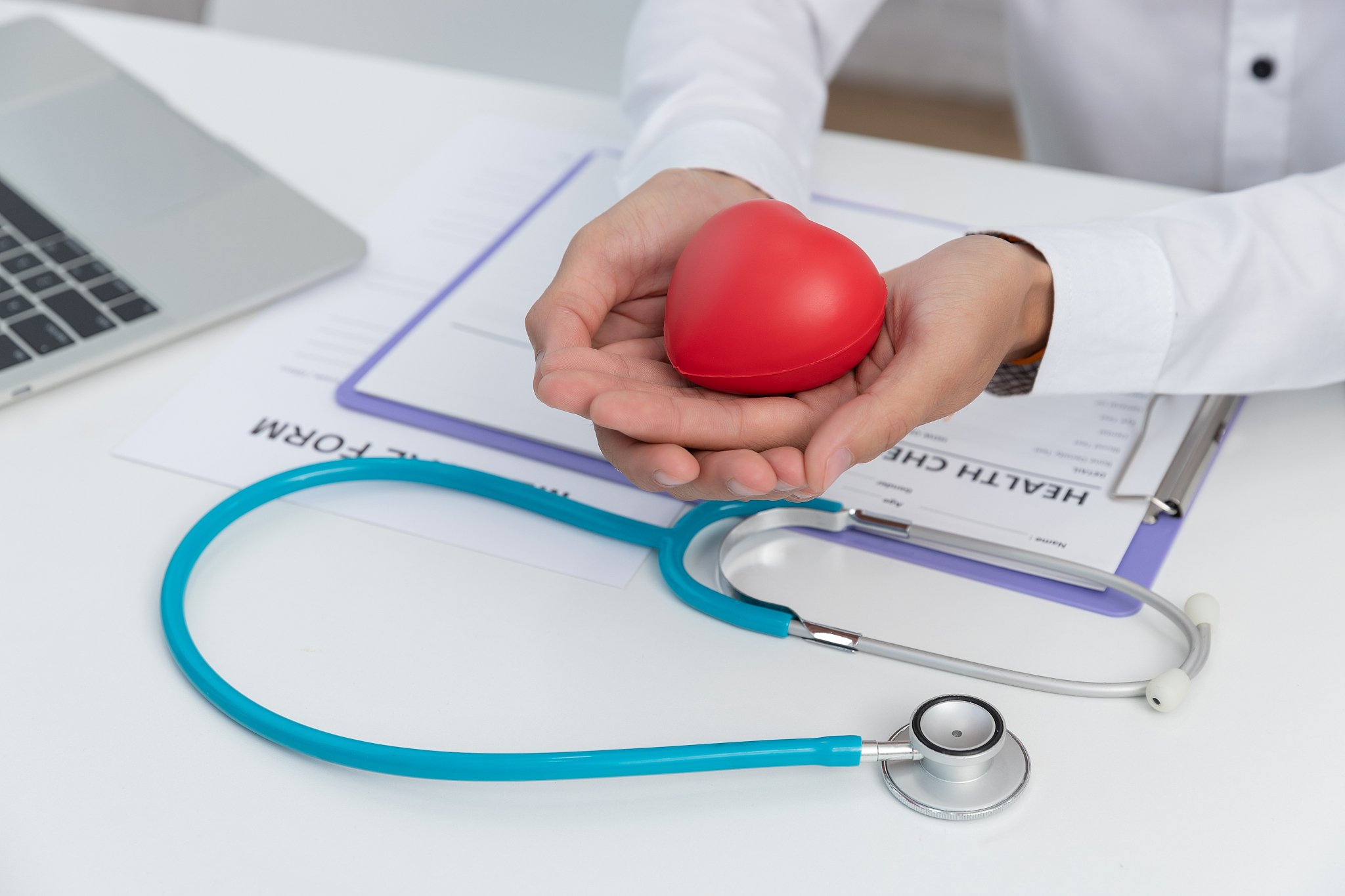 healthcare and medical concept, doctor holding heart ball and ex