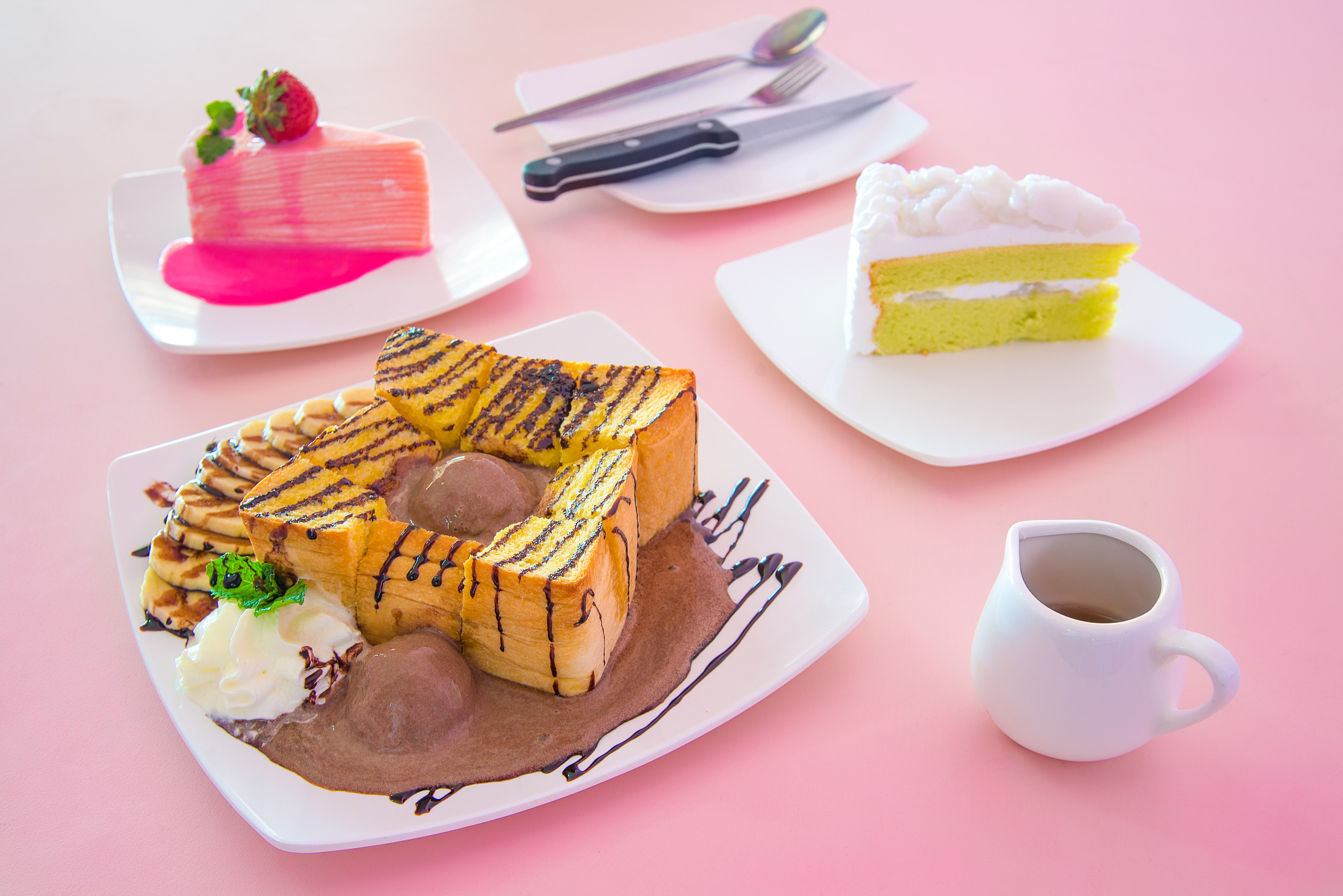 honey toast banana and chocolate on pink table