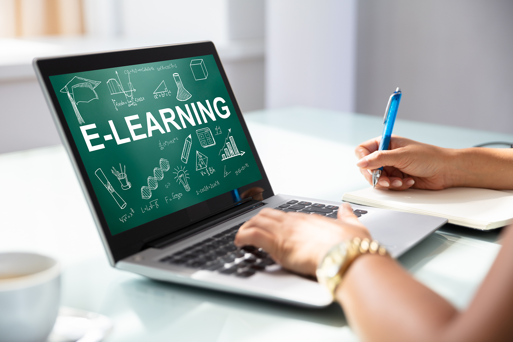 businesswoman using laptop with e-learning concept on screen