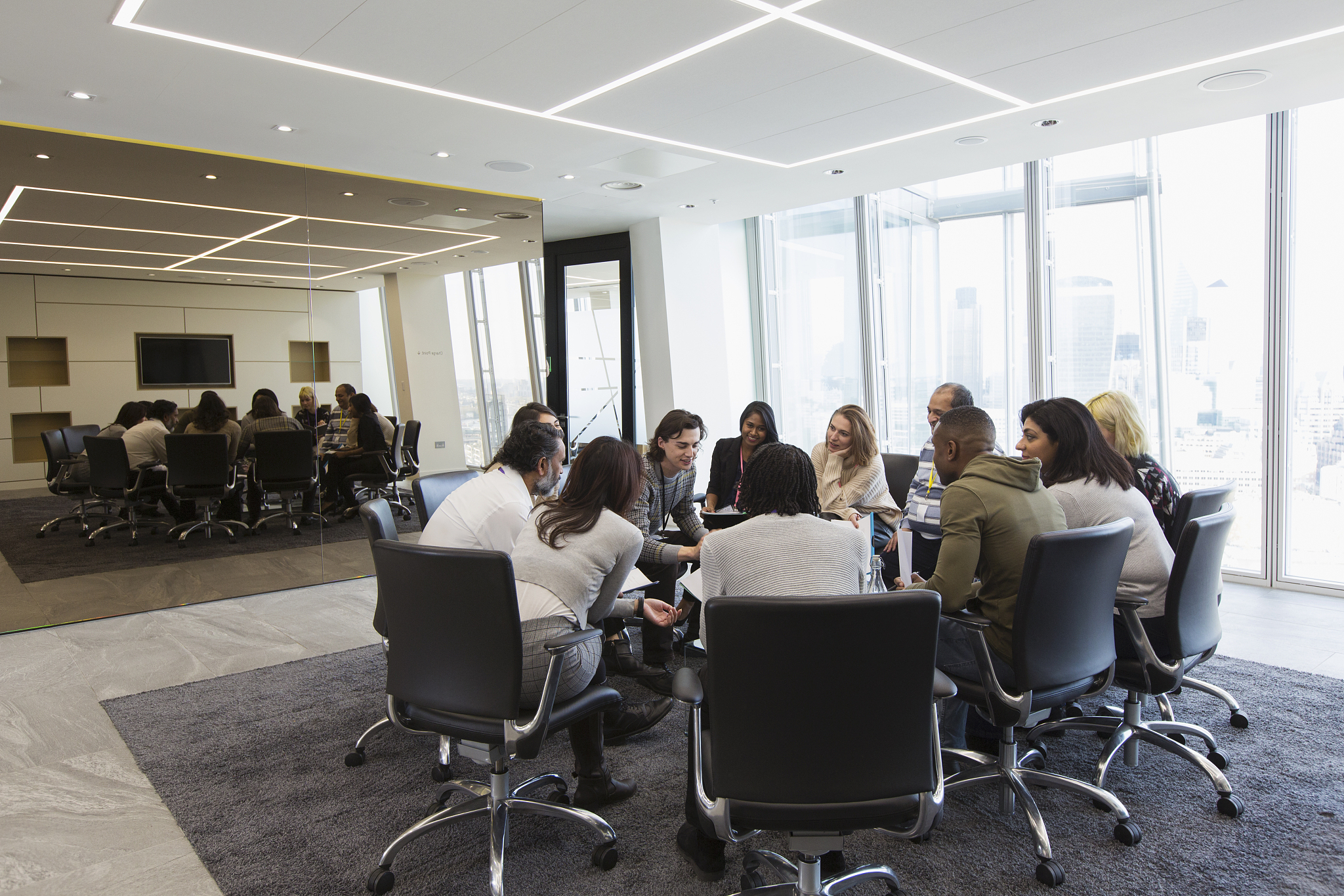 business people meeting in circle in conference room