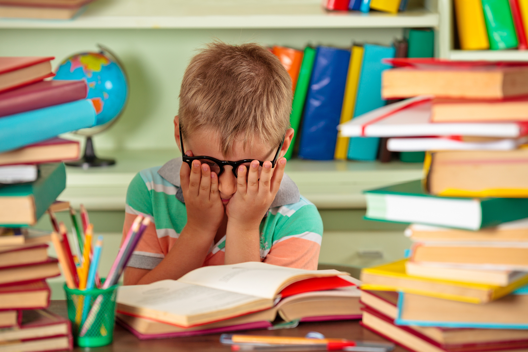 tired boy  in the library.