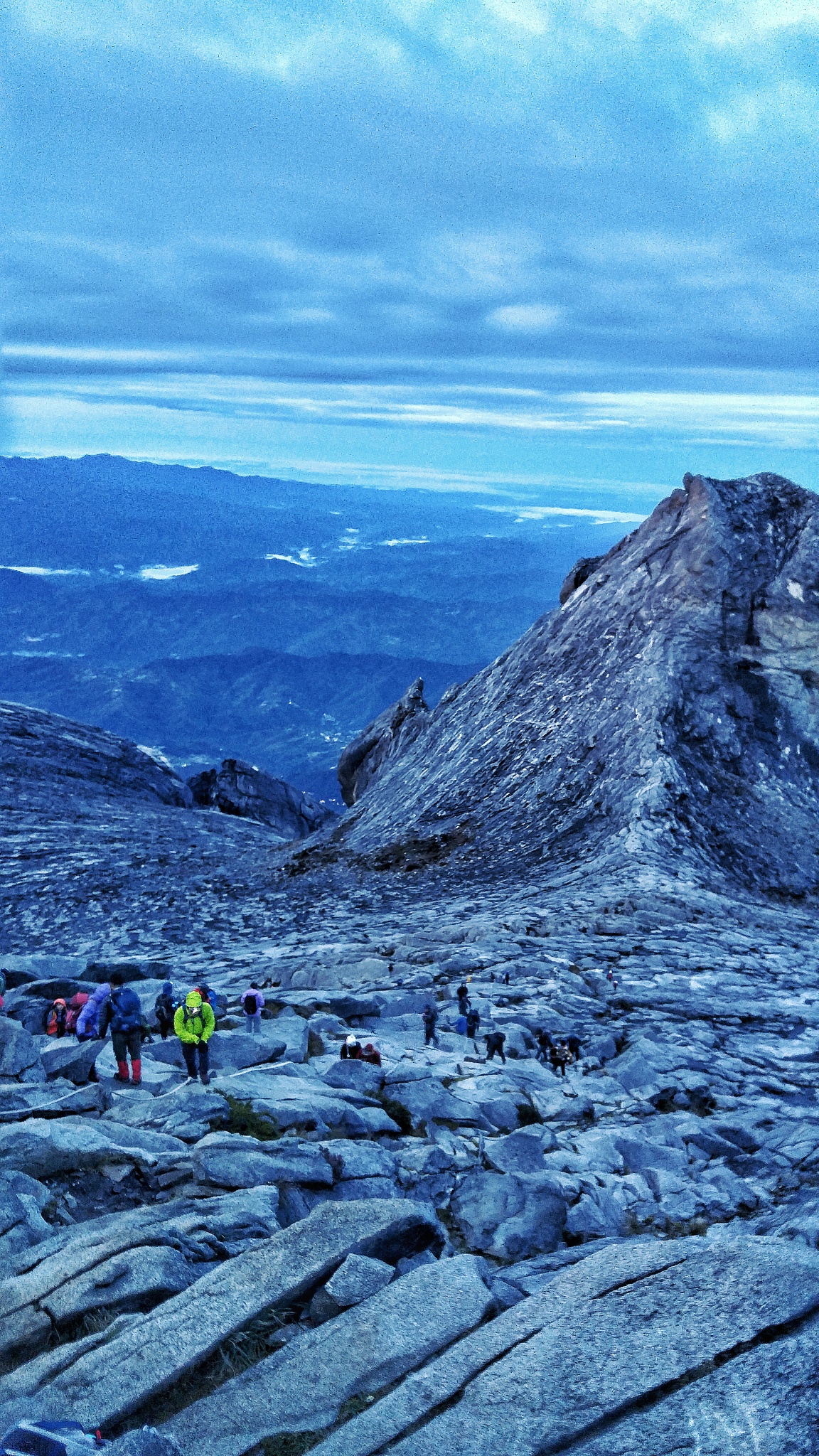 people on mountain against sky