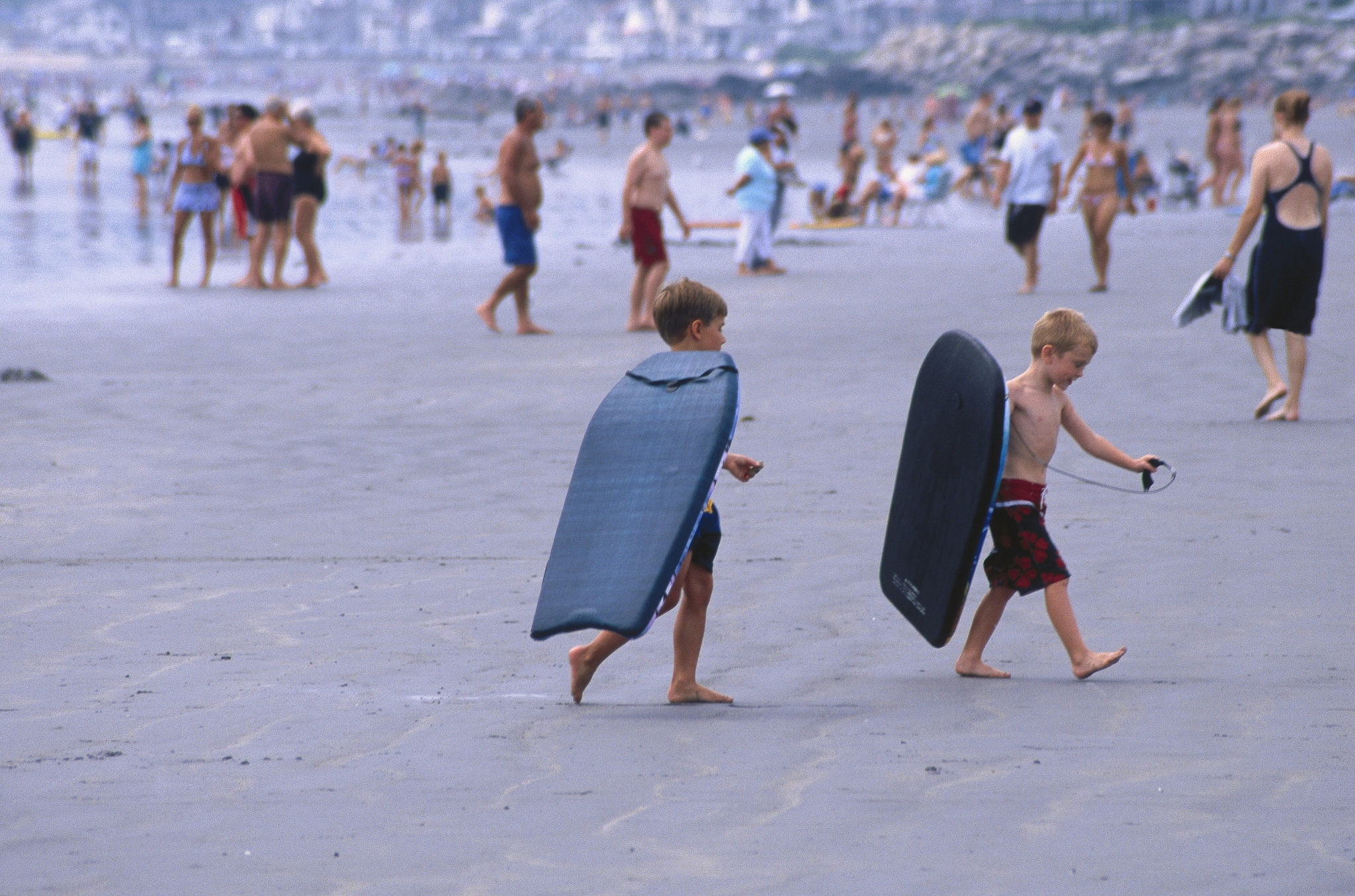 young boys w/ boogie boards on the beach