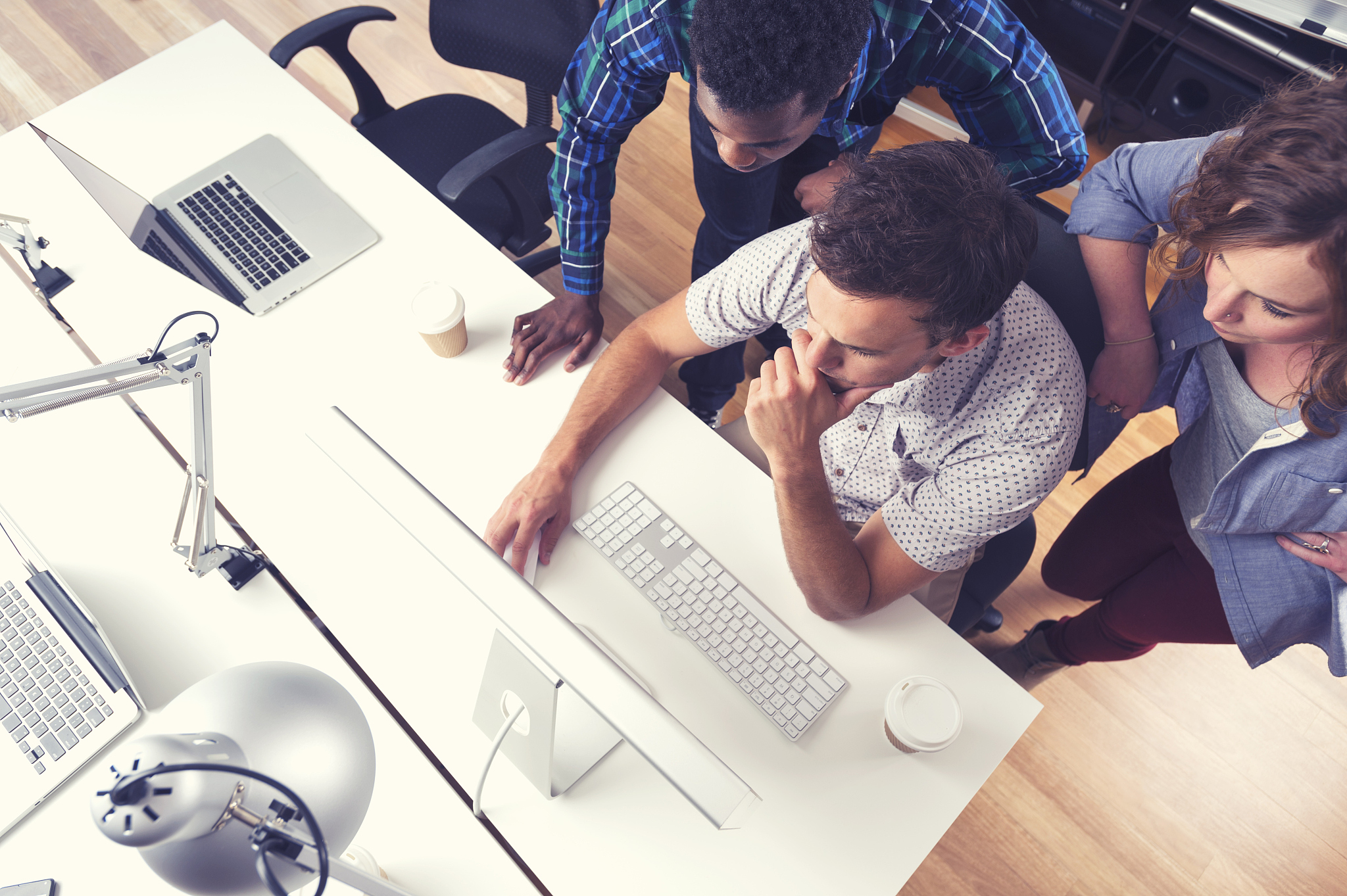 3 people working together in a small business office.