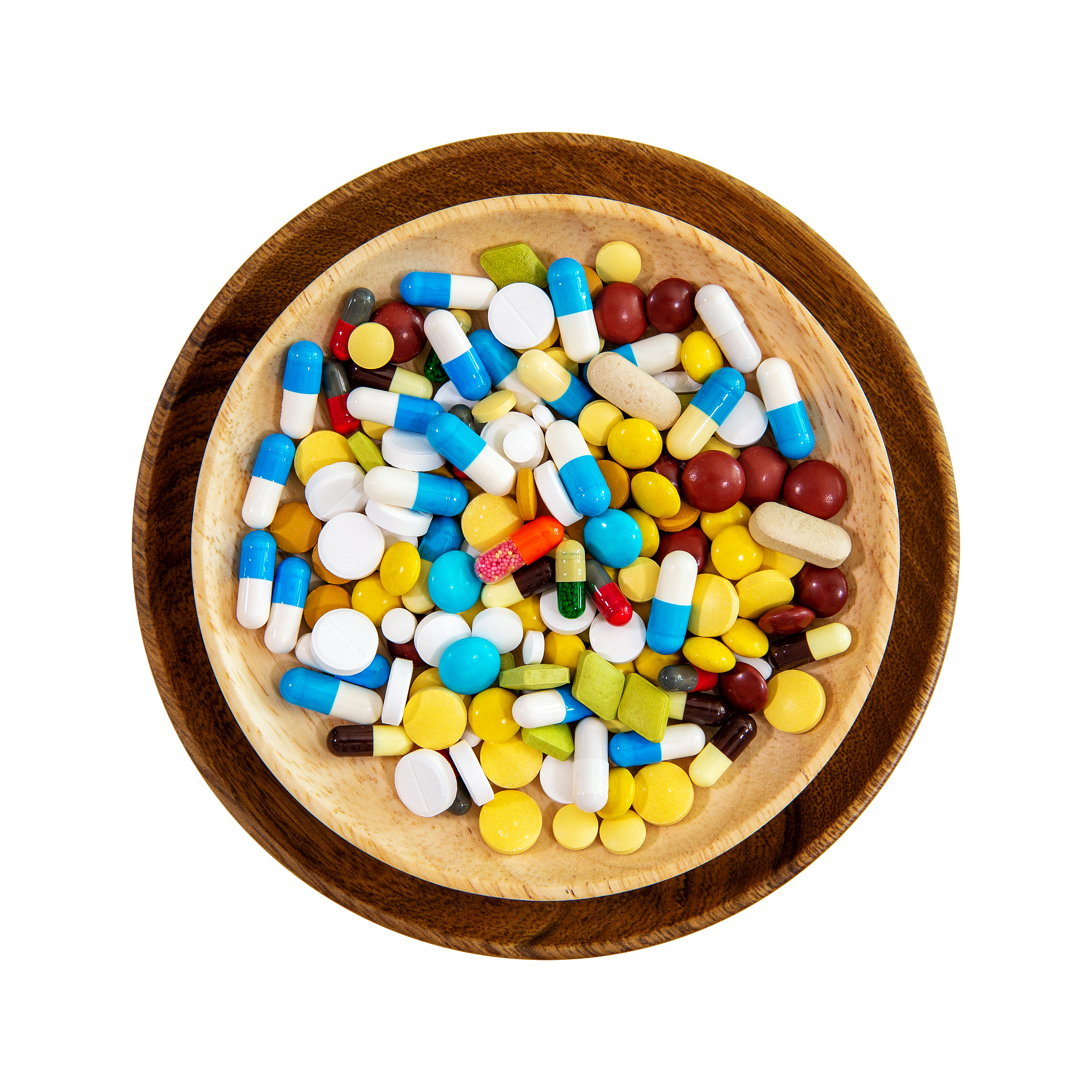 (clipping path) pill on the wood plate isolated