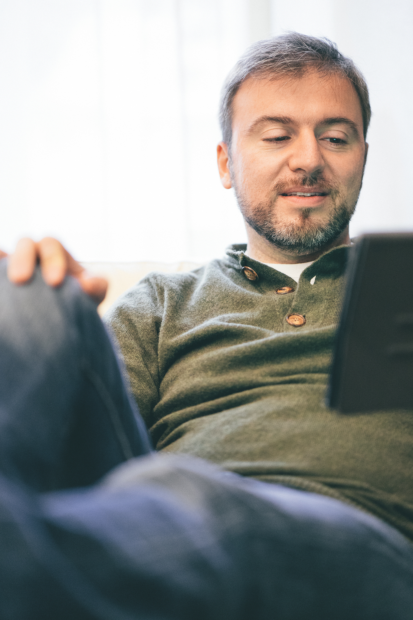man using digital tablet at home