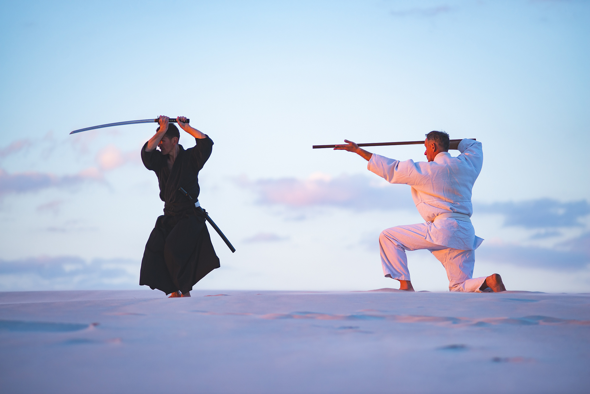 concentrated men, in japanese clothes, are practicing martial ar