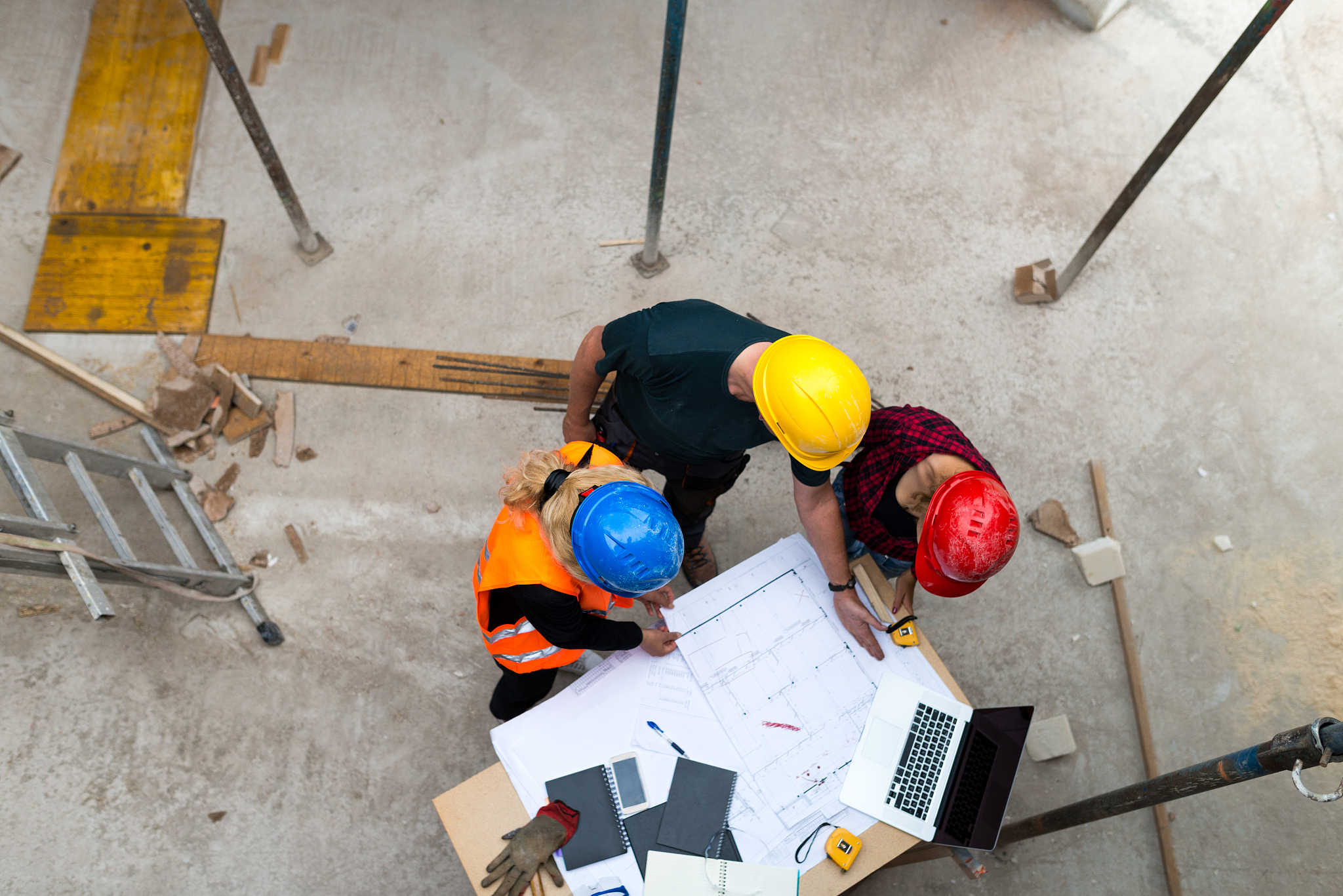 a group of people is reviewing plans for construction work