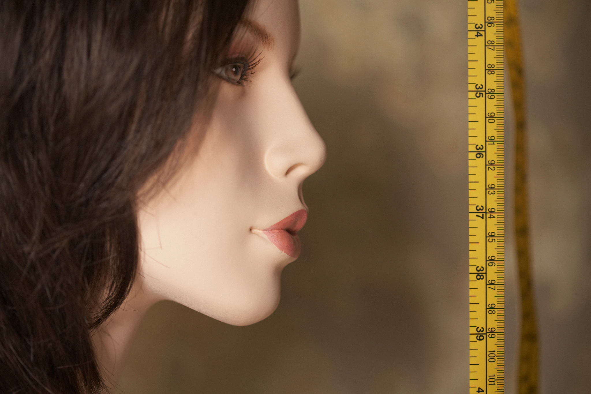 tape measure near a mannequins face