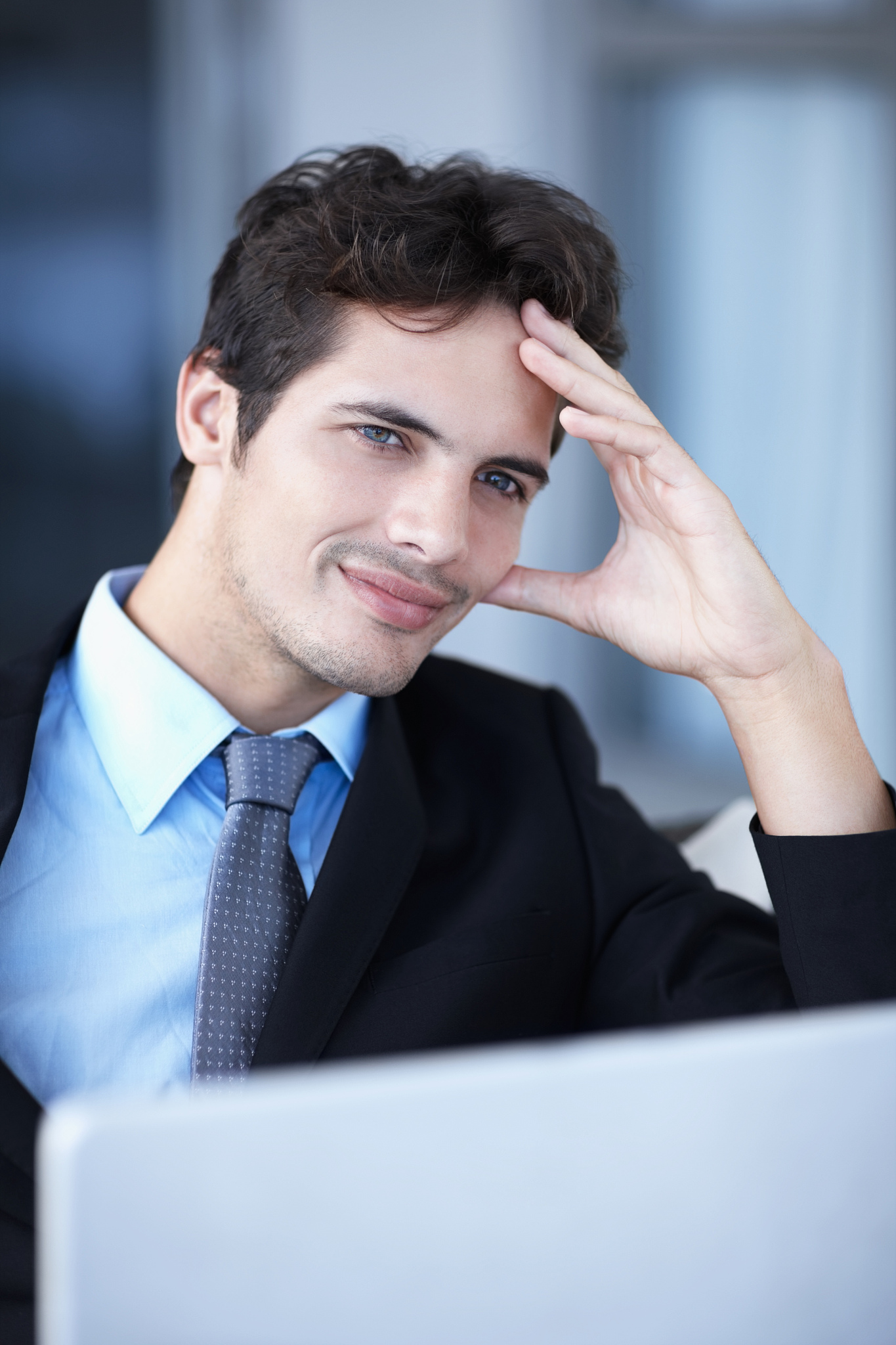 thoughtful businessman in front of a laptop