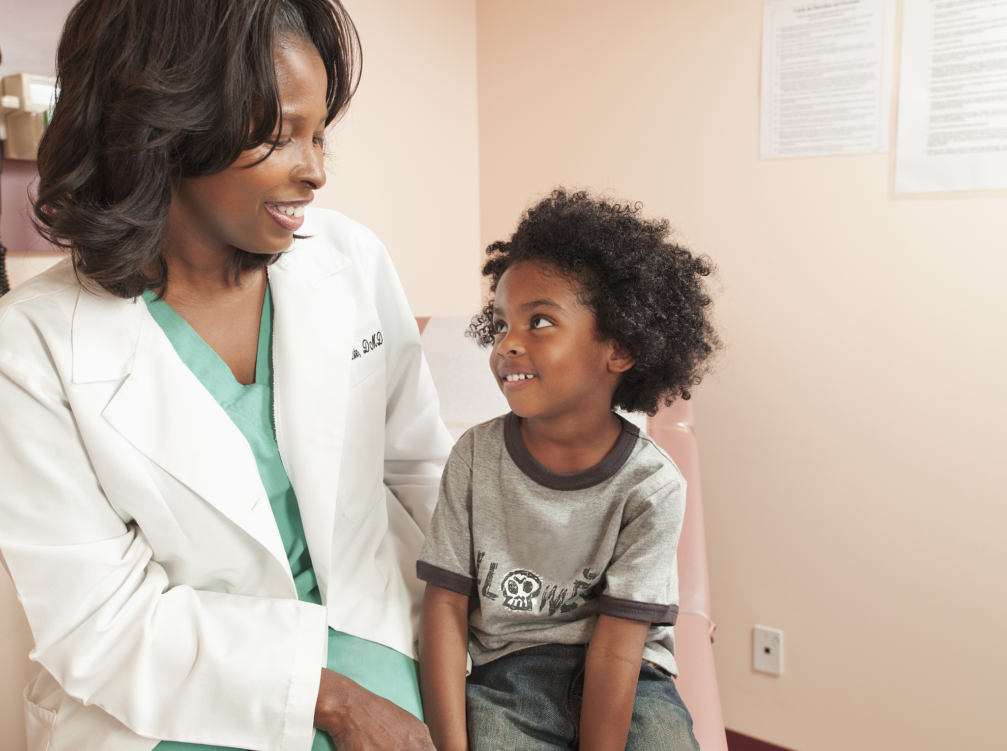 female doctor and little boy smiling at each other