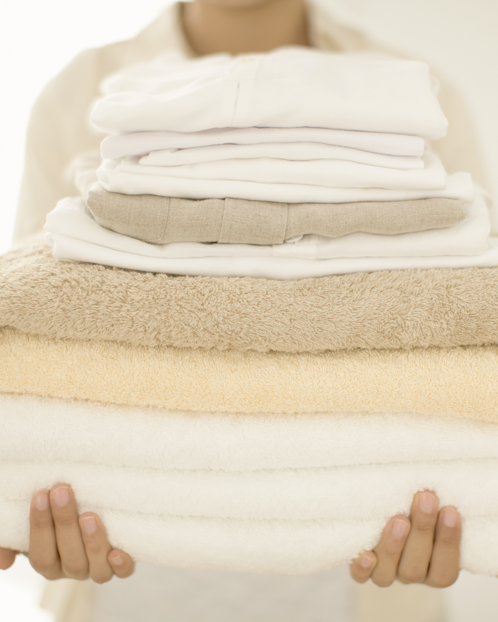 woman with stack of towels