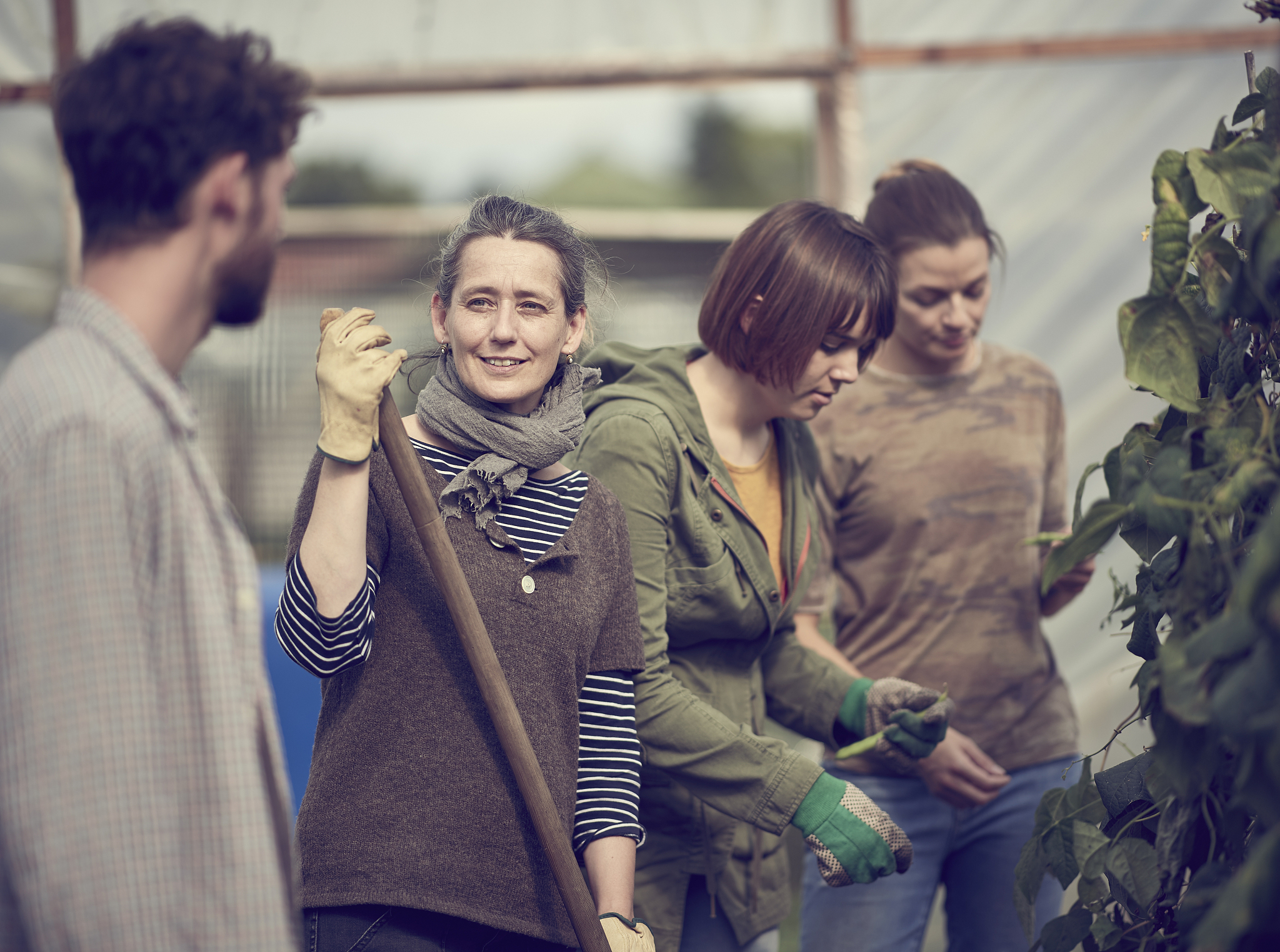 group of community farmers talking whilst working in their allot