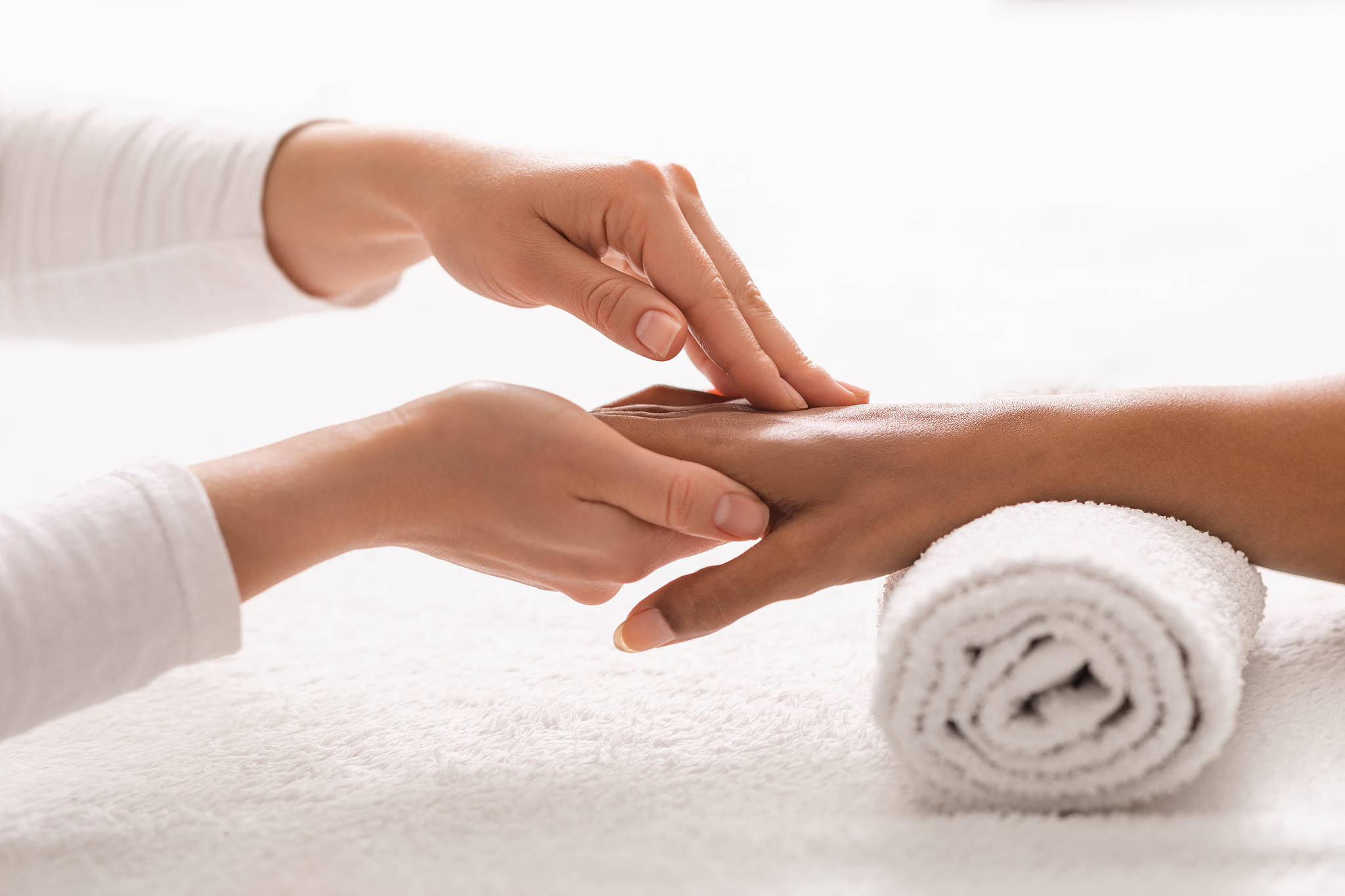 acupuncture hand massage for african woman at spa