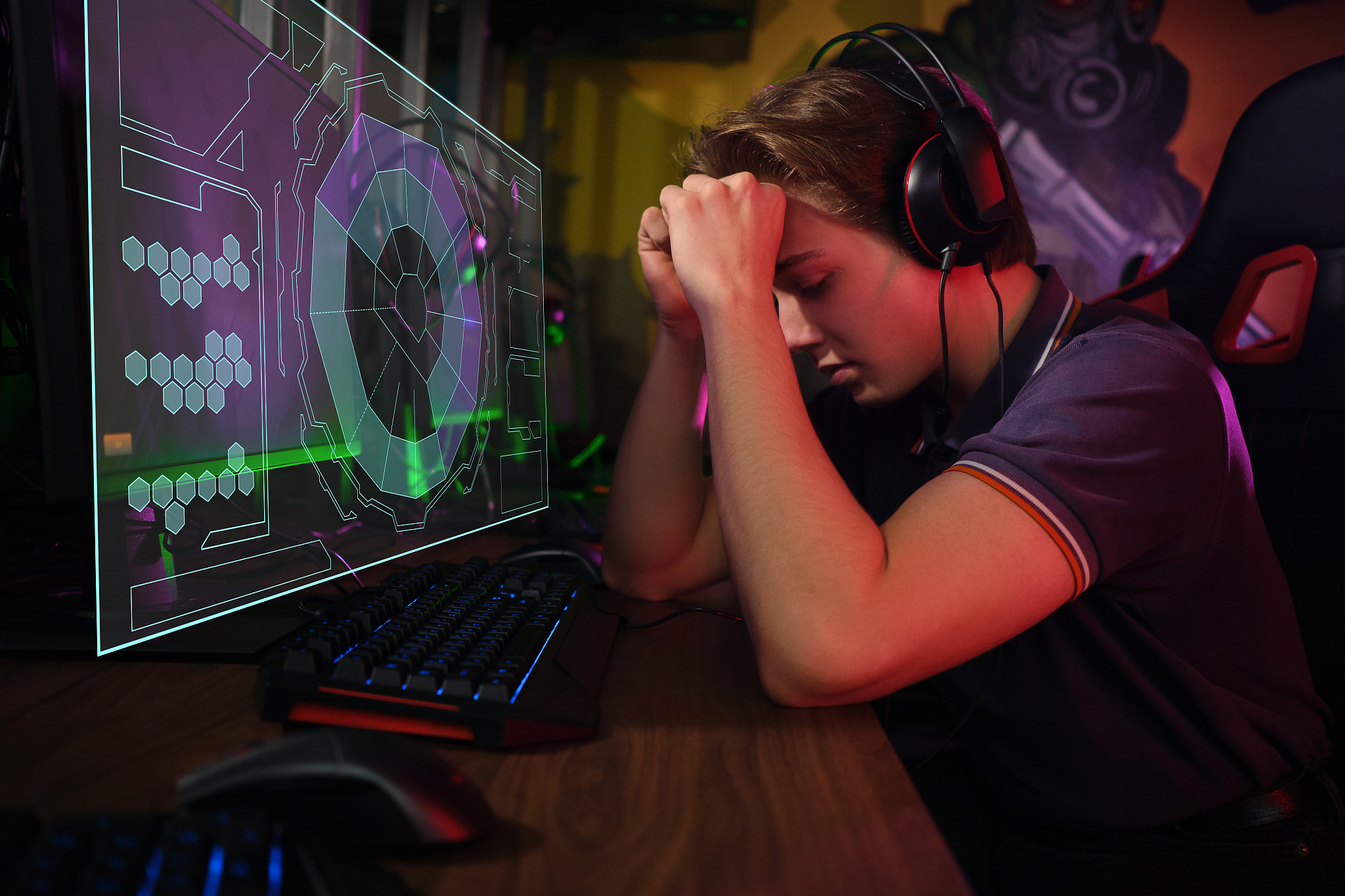 professional young caucasian gamer playing online on his pc. he 