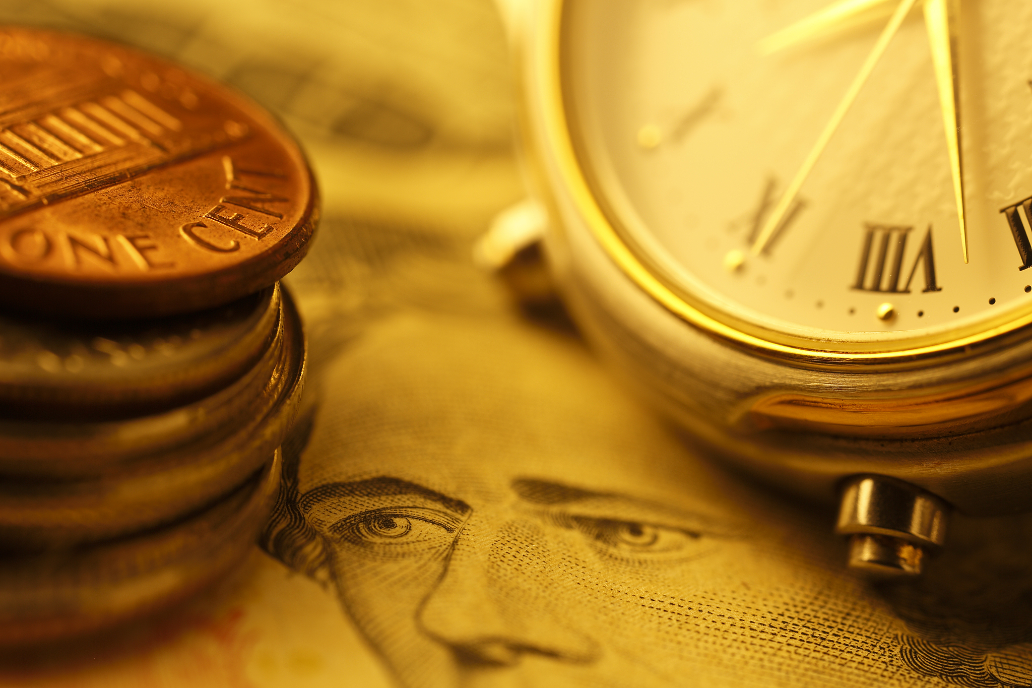 time and money. gold tone. close up