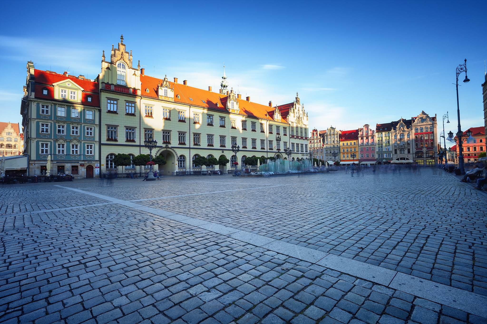 wroclaw market square at morning, people blurred in motion