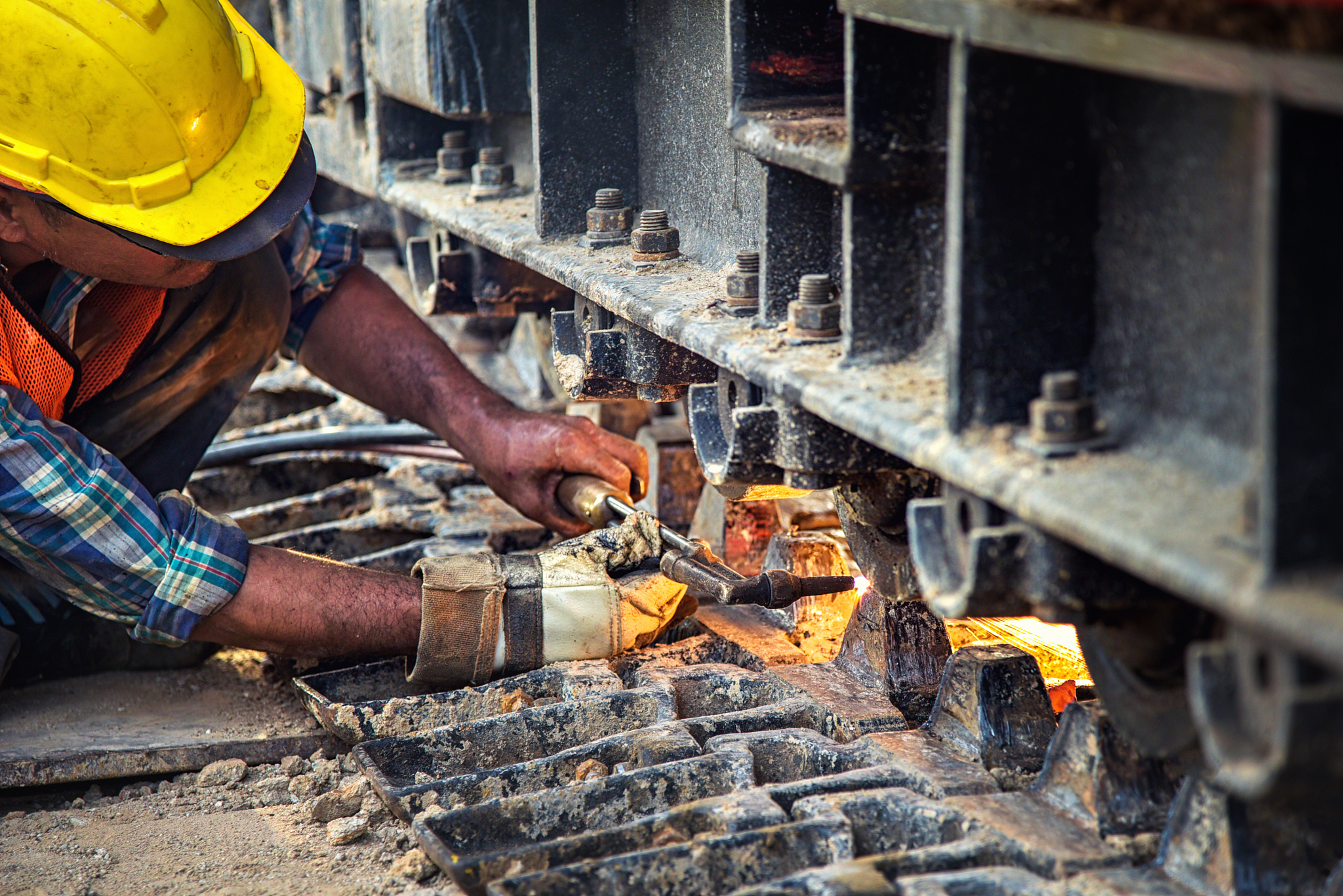 welder of metal welding with sparks and smoke in manufacturing