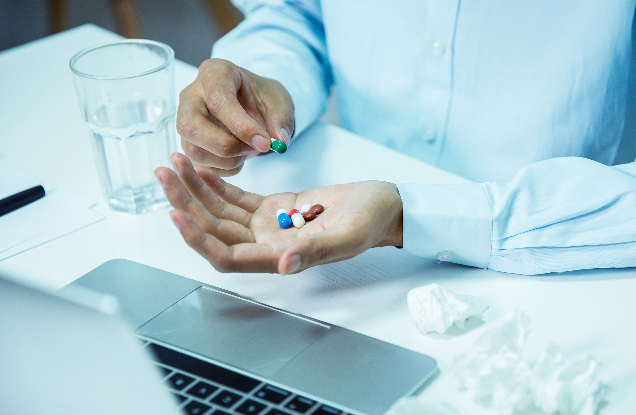 man taking pills in office