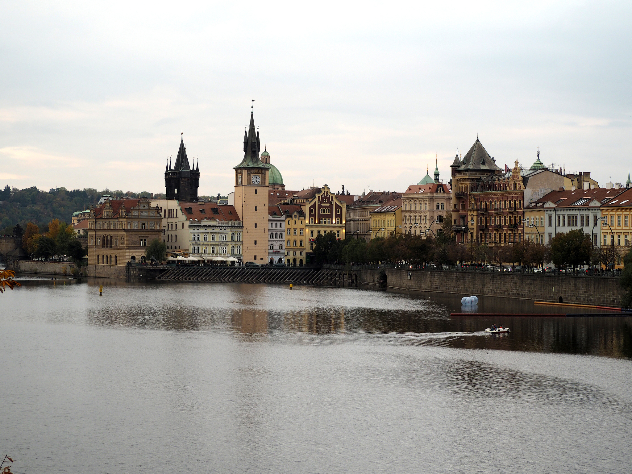buildings by river against sky