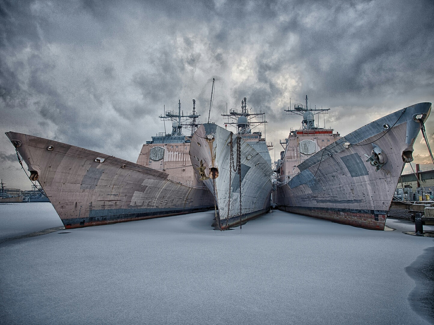 ships in frozen sea against cloudy sky