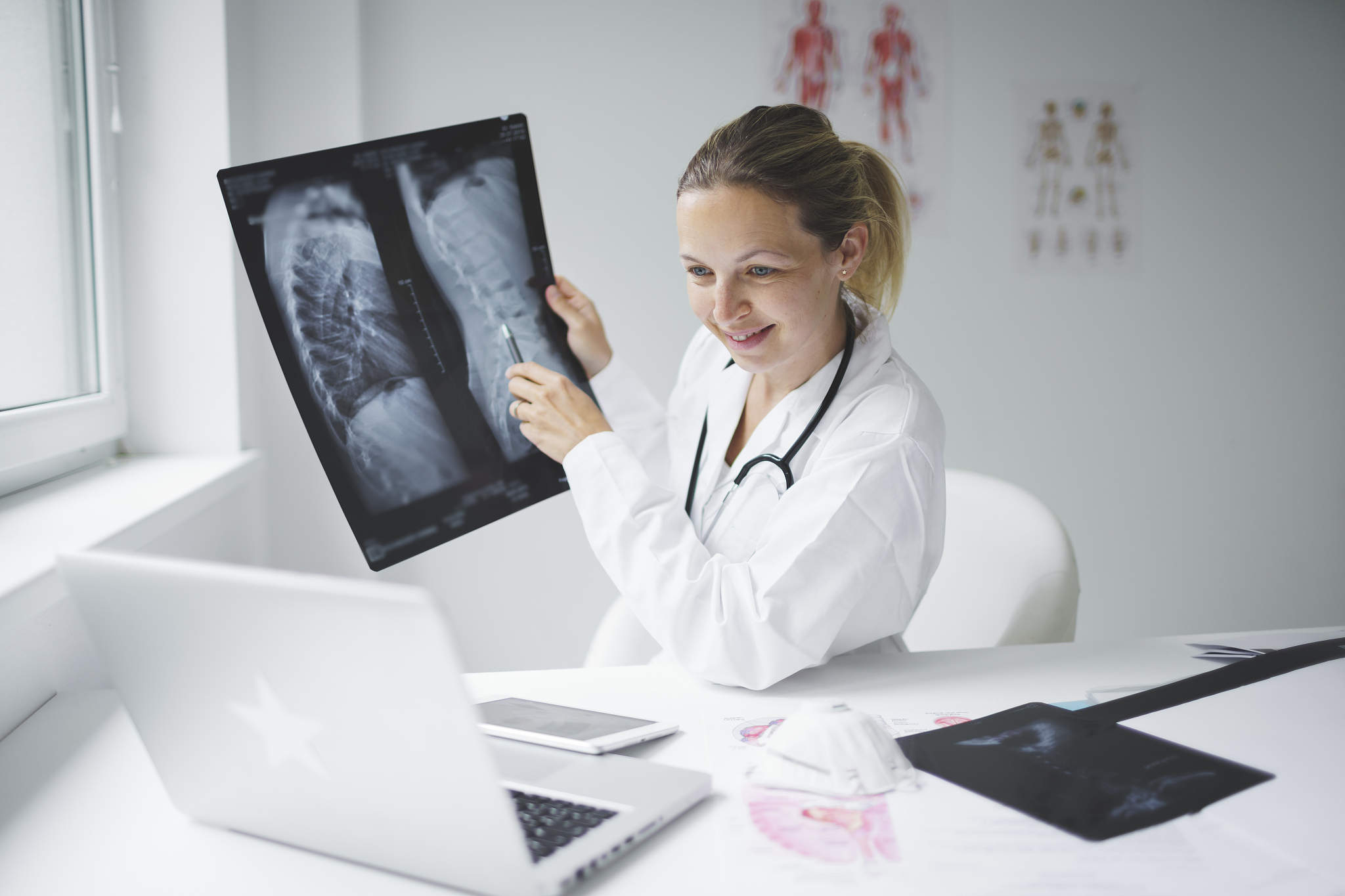 pretty doctor discusses x-ray image online with her patient