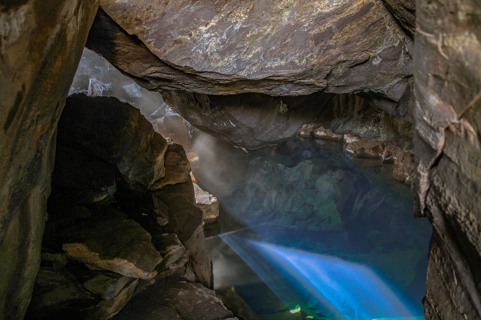 steaming waters of grjotagja cave in iceland.