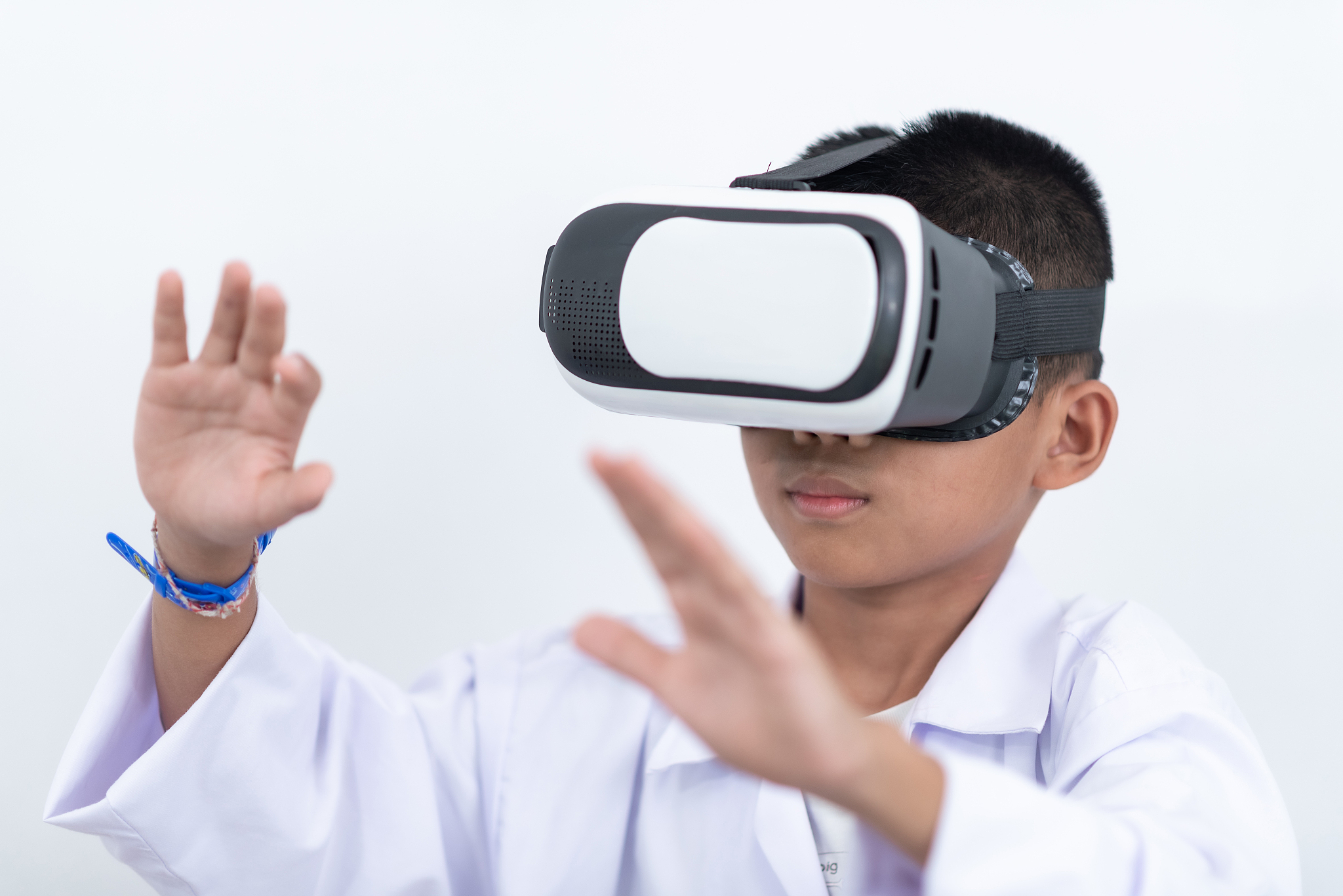 happy teen boy wearing virtual reality watching movies or playin