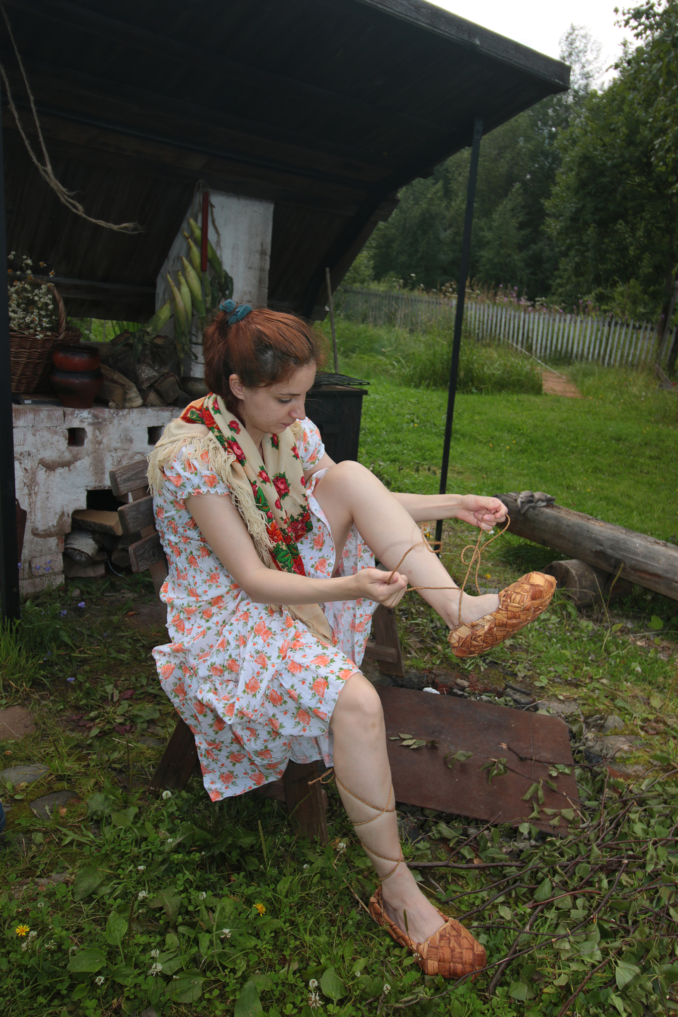 beautiful girl with a bouquet in sandals
