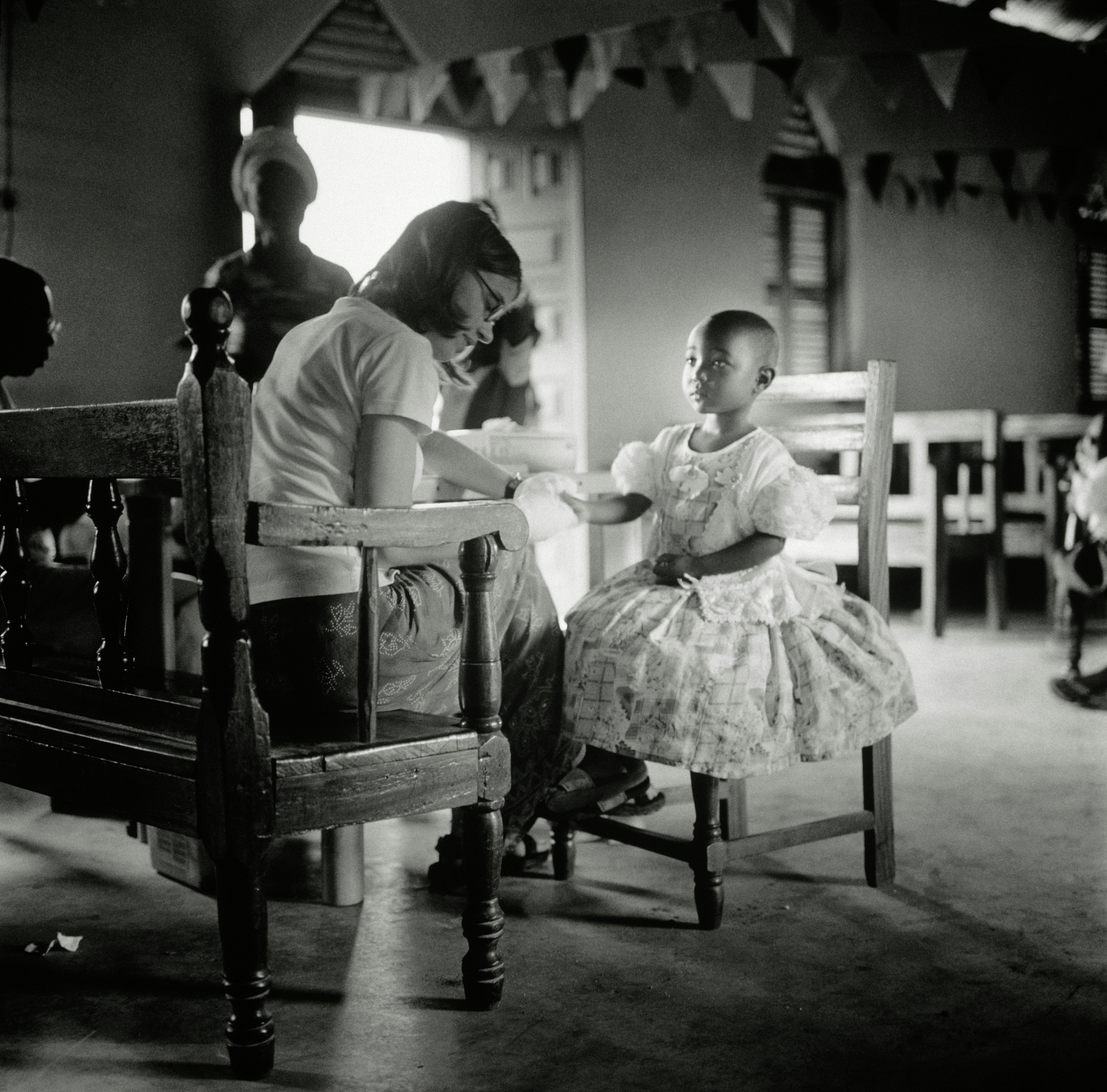 female doctor treating girl in ghana