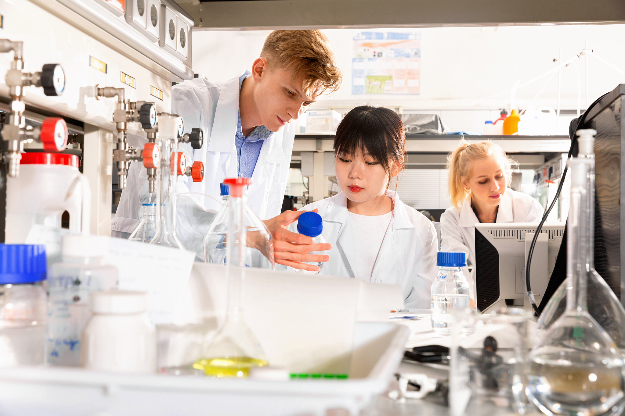 portrait of group of european and chinese scientists working tog