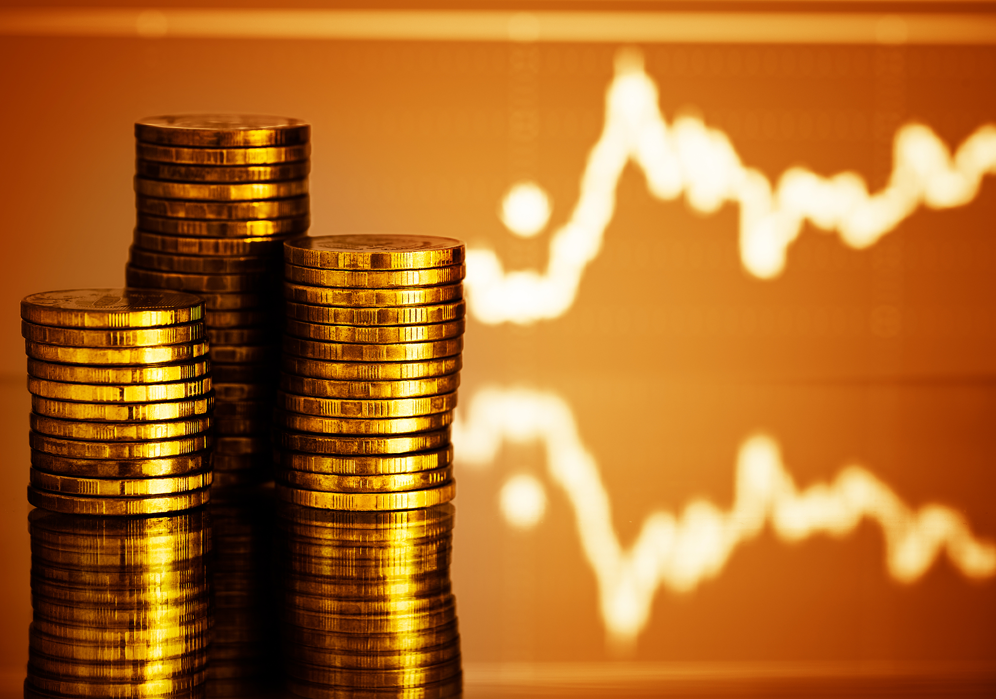 gold money. fluctuating graph on red background.
