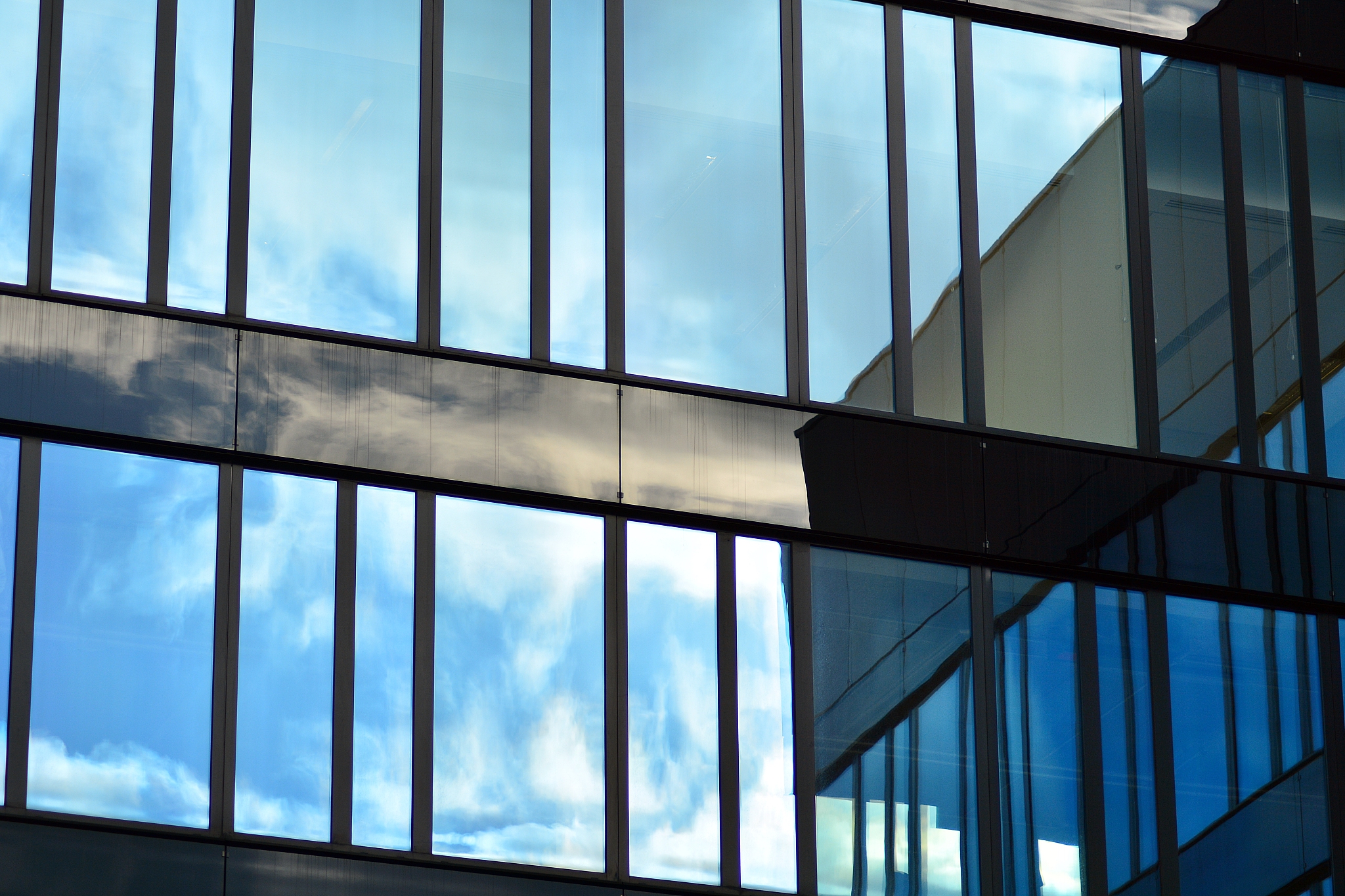 modern building with reflected sky and cloud in glass window