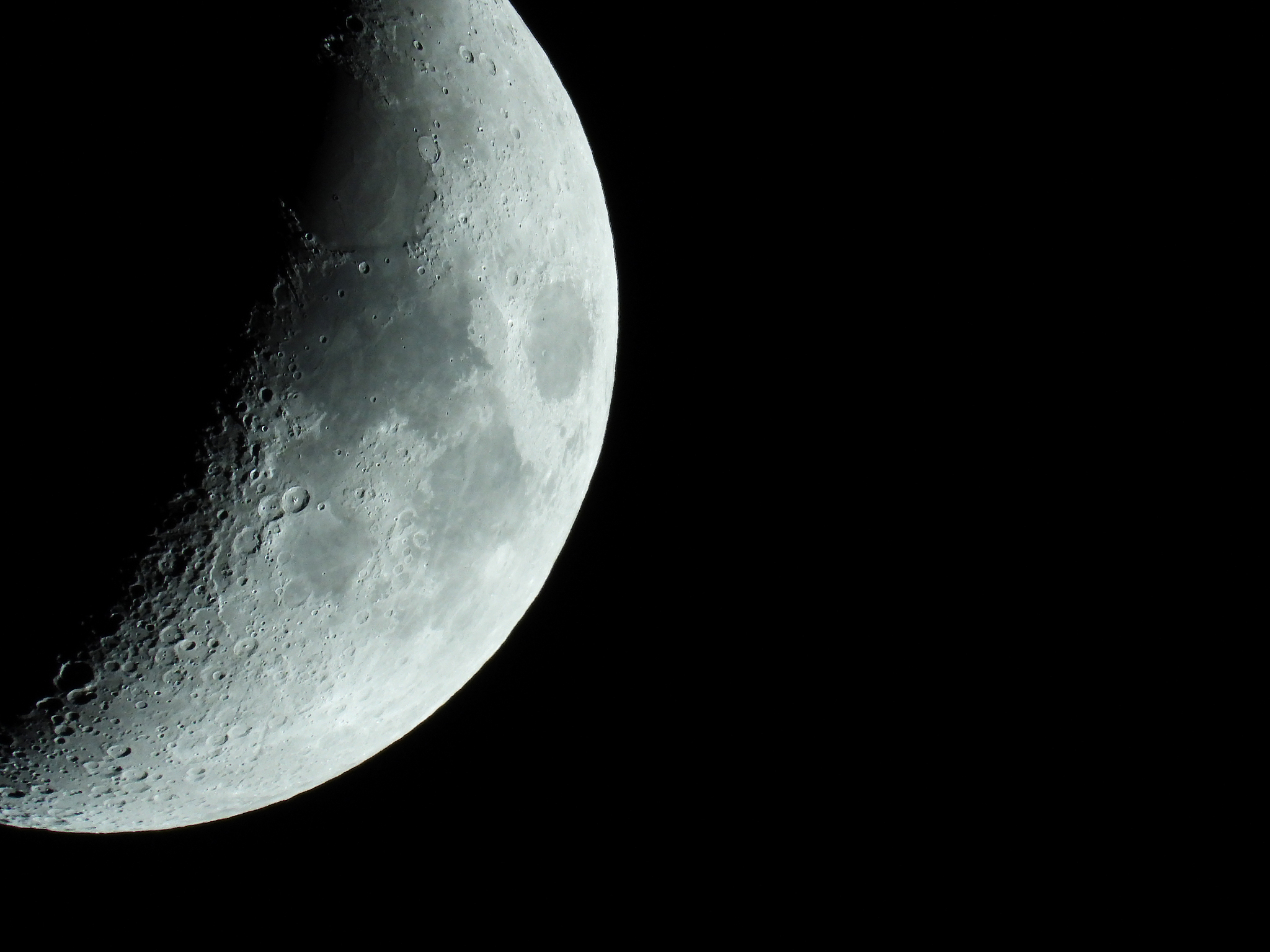 a very sharp close-up of the rising crescent moon in the night s