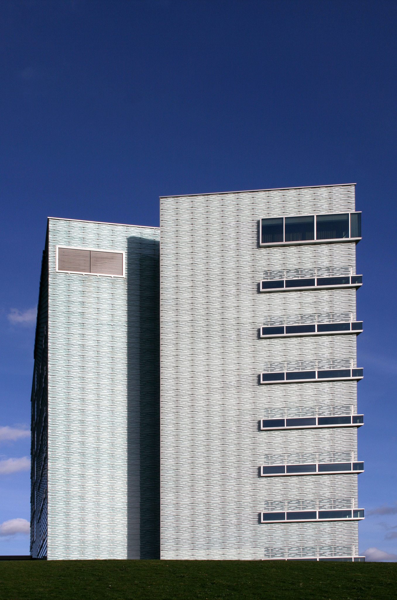 请把下面的这段话翻译成英语：吊脚楼的民族特征正屋式吊脚楼主要是苗族、侗族、布依族等民族的民间在建造和使用当然在这些区域内的汉族和其他少数民族也在建造和使用这种建筑。在建造和使用这种吊脚楼的过程中各个民族又有各自的文化旨趣和生境知识的特点。比较而言黔东南及桂北的苗族、侗族在这种建筑形态的建造和利用上 特点相对比较接近都是全木质的细微差异是苗族比较强调高悬侗族比较强调围绕鼓楼簇拥；黔西南、黔南的布依族