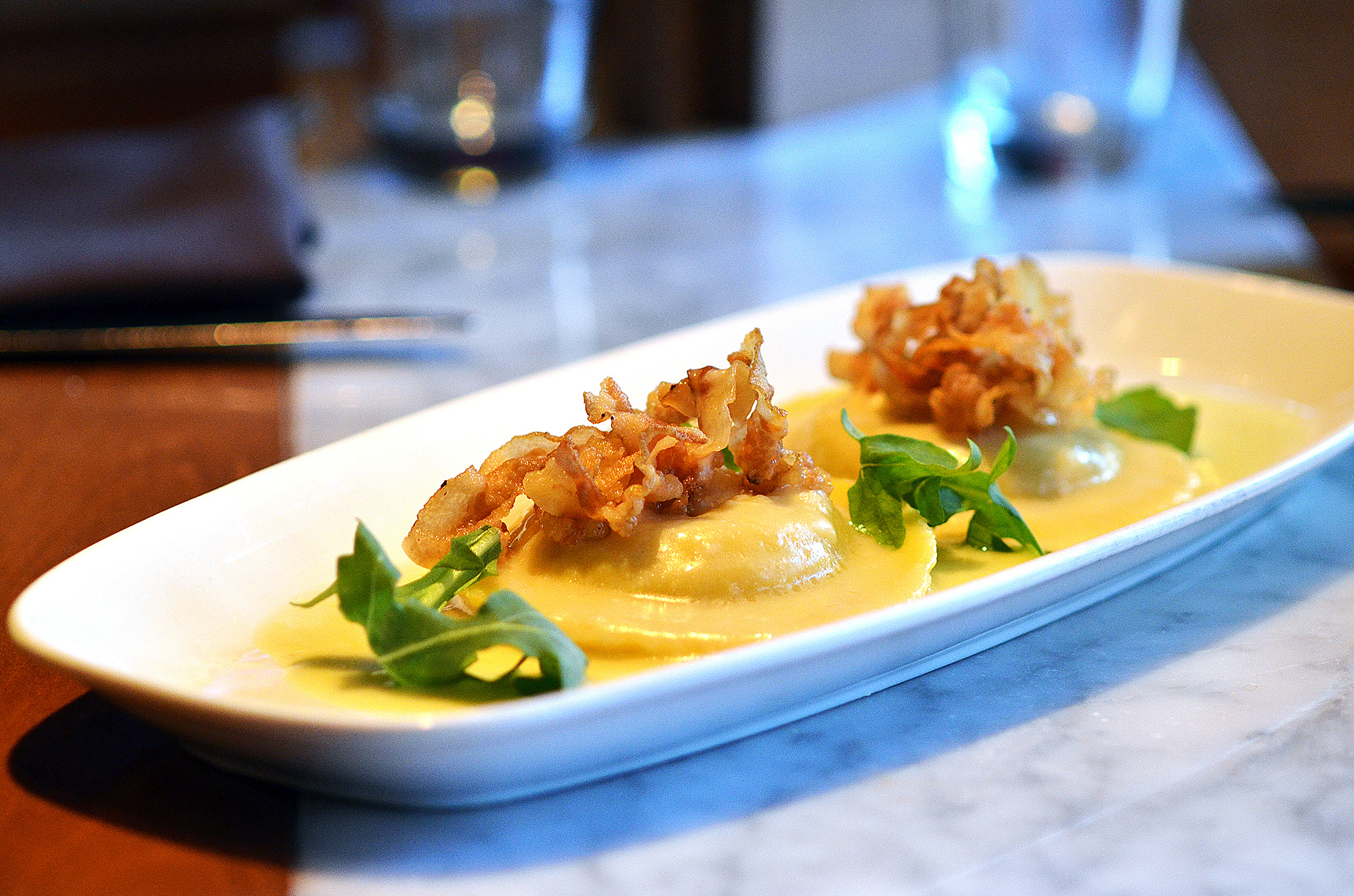 handmade ravioli topped with crispy bacon