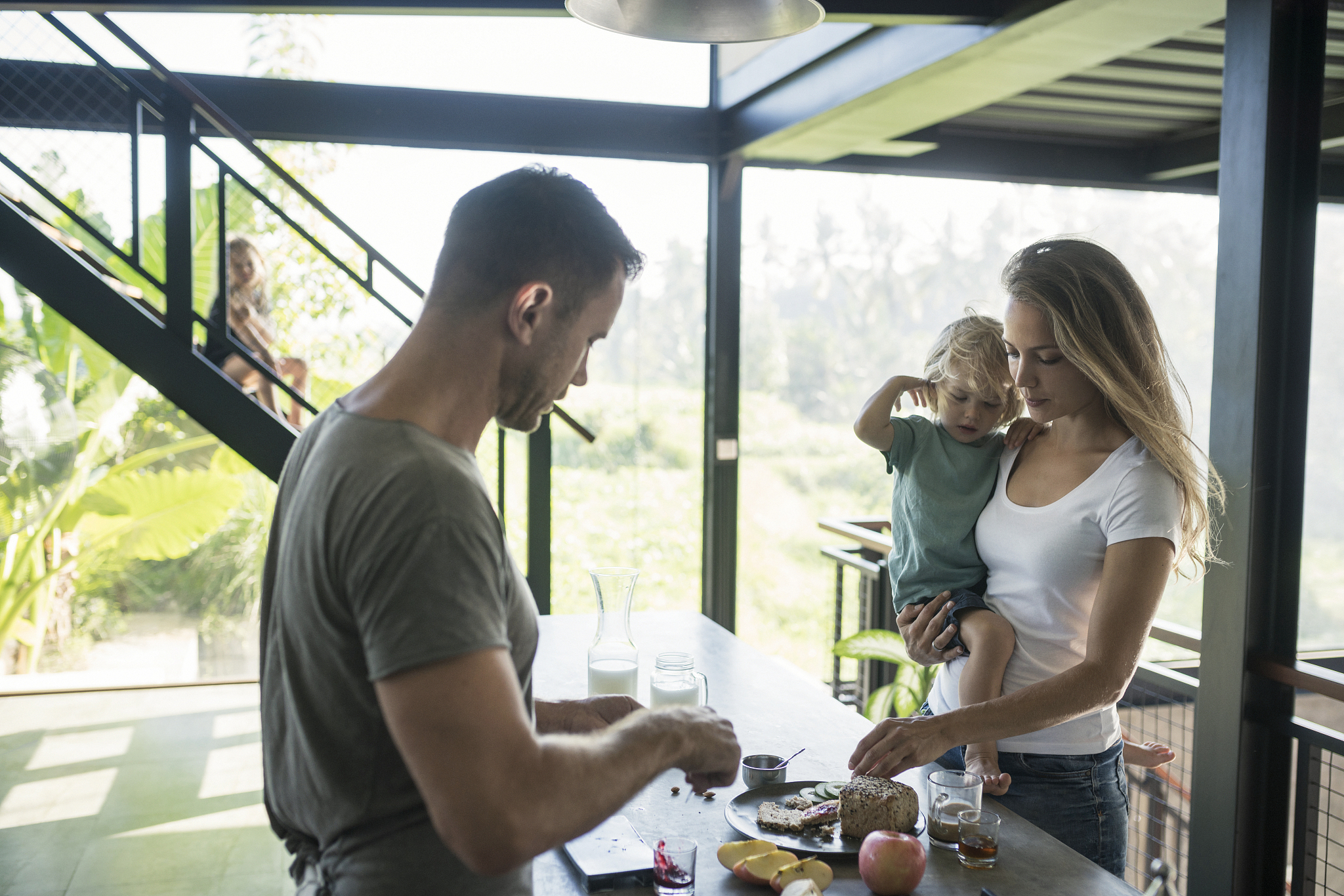 family preparing healthy breakfast in comfortable kitchen