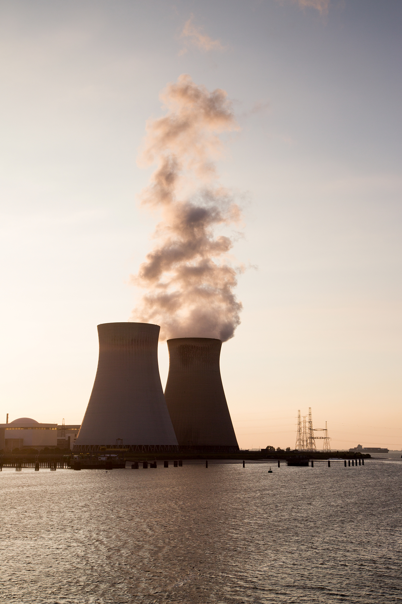 doel nuclear power station on scheldt at sunset