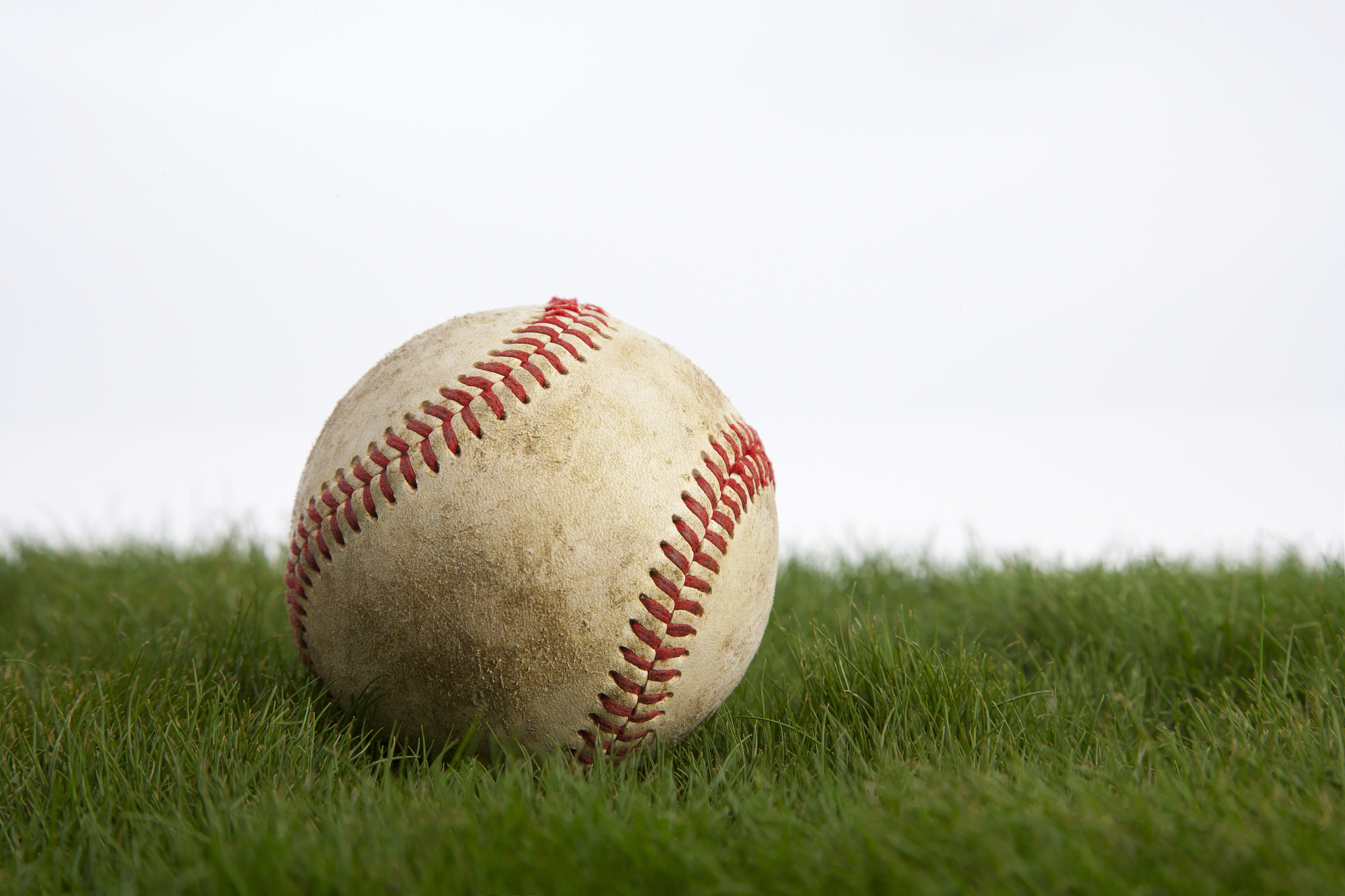 grungy baseball on green grass