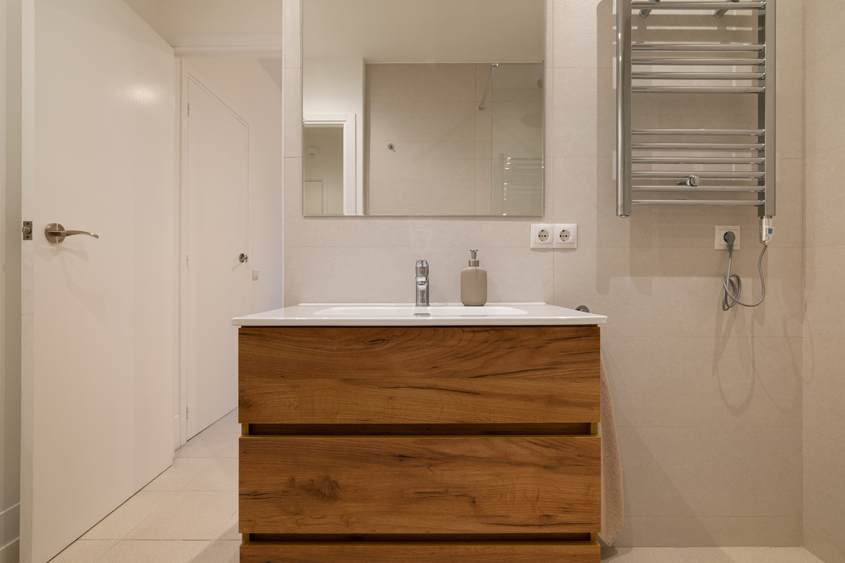 卫生间 大 有浴缸 跟浴室柜相连 浴室柜台面上右侧有高柜 洗手盆在中间右侧台面延申到头转角处有浴缸