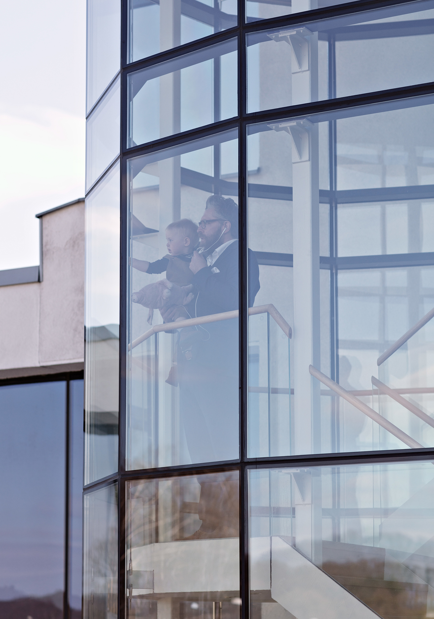 businessman with son standing in office seen through glass