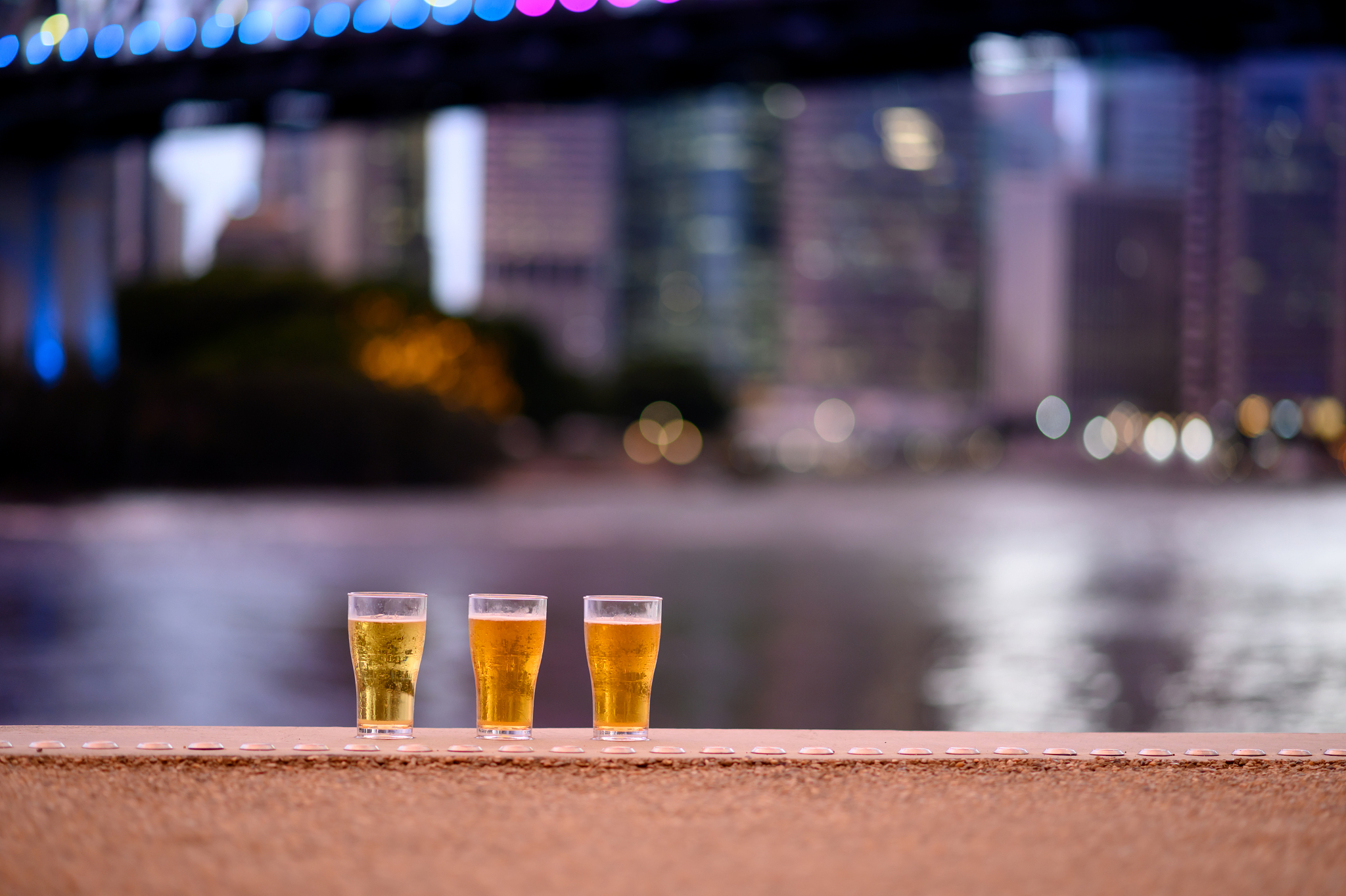 three glass of beer and city background