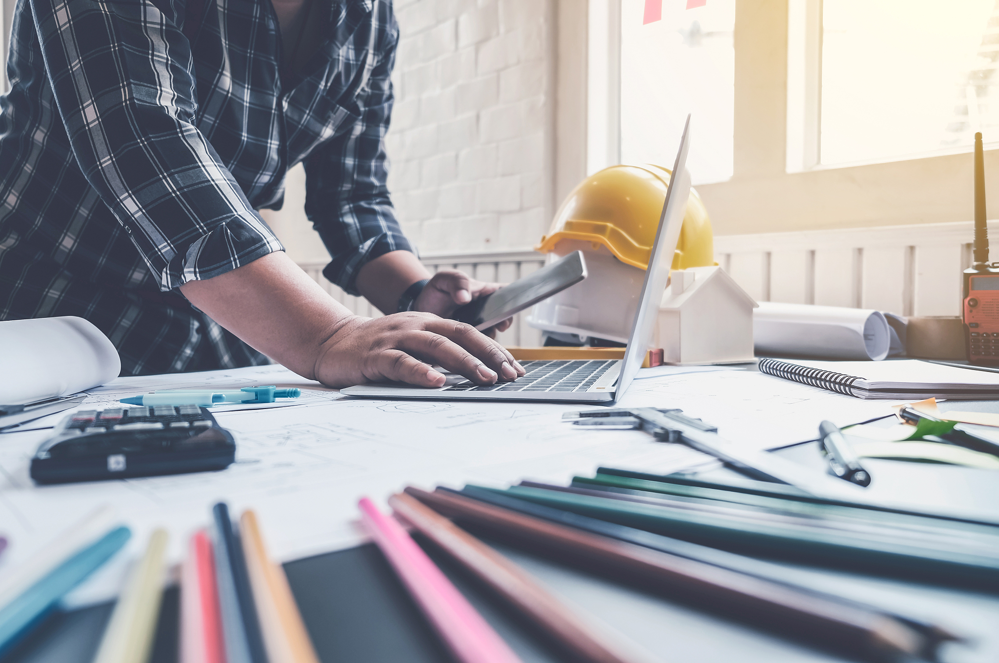 engineer man working in the office, drawing the construction pro