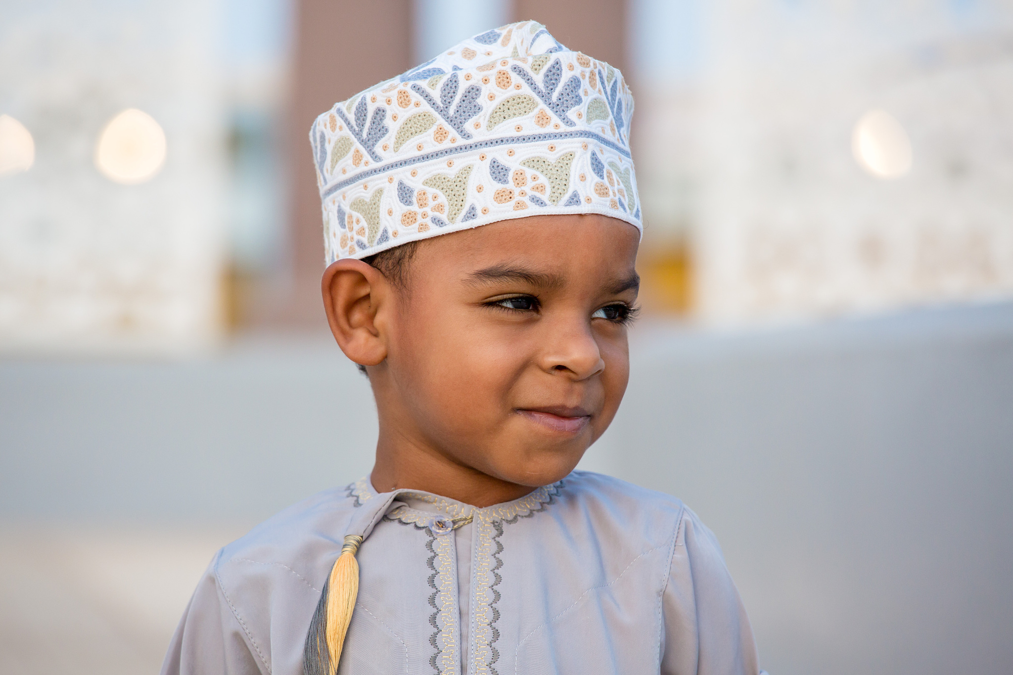 cute omani boy wearing dish dasha in the park